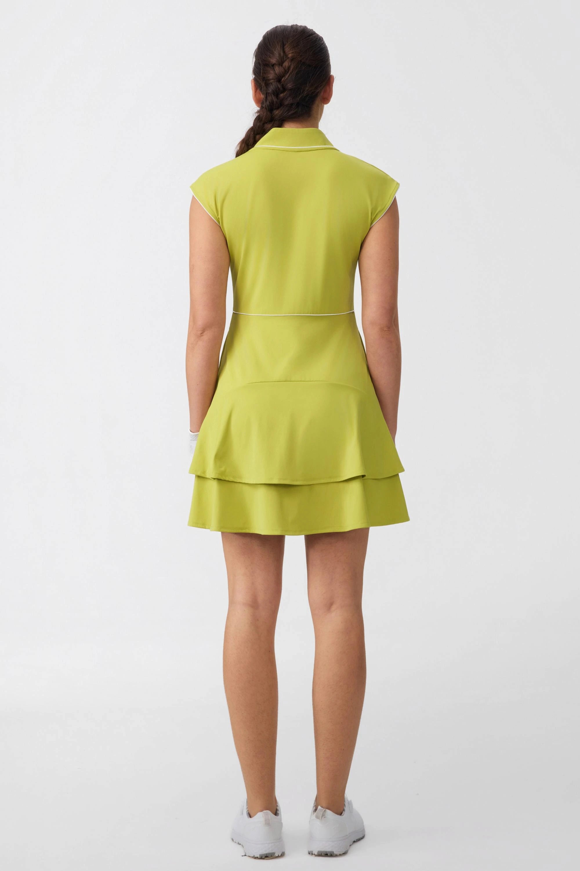 Back view of women's citron yellow zip-front golf dress