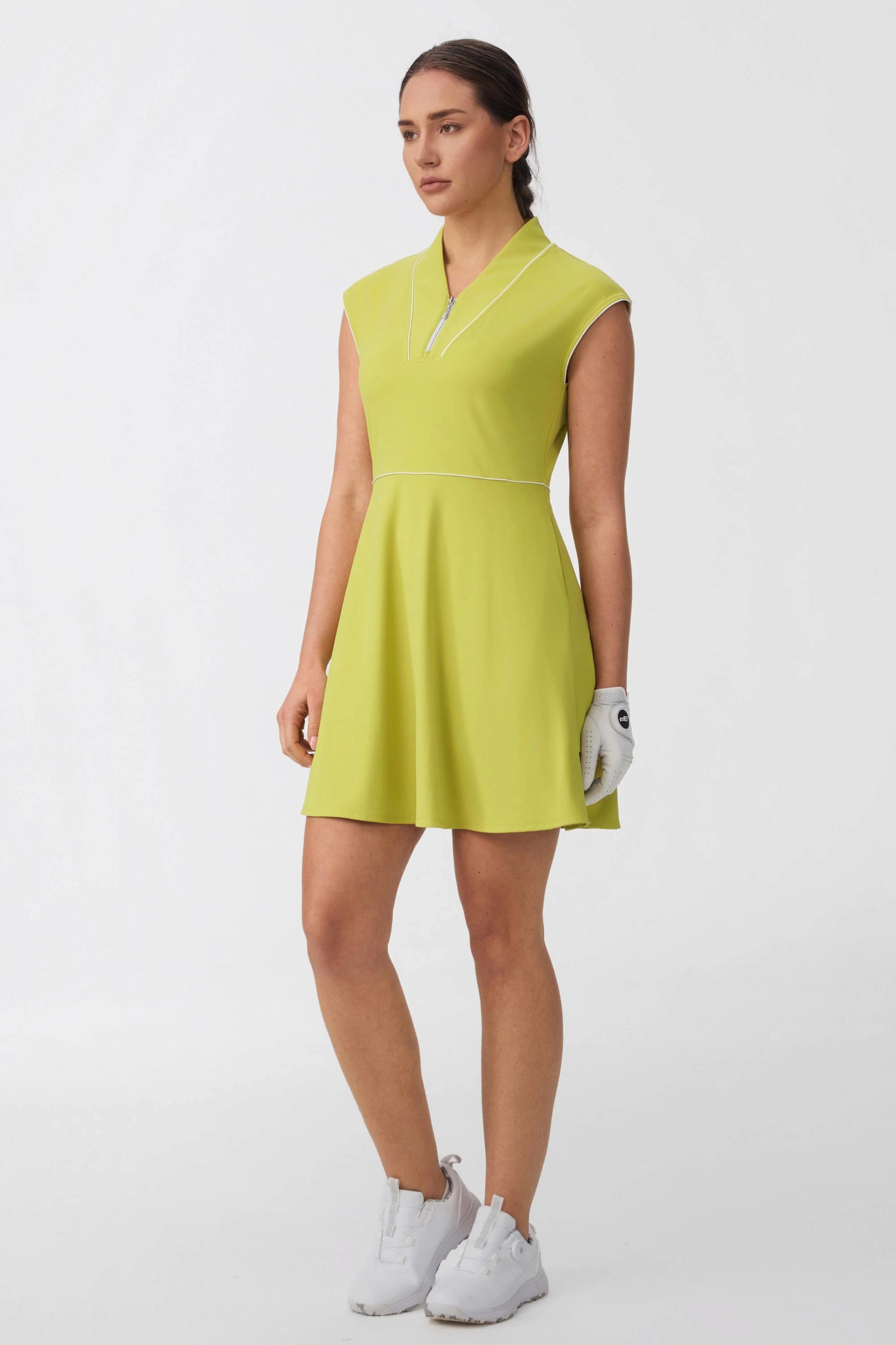 Side view of women's citron yellow cap sleeve golf dress with a flared skirt