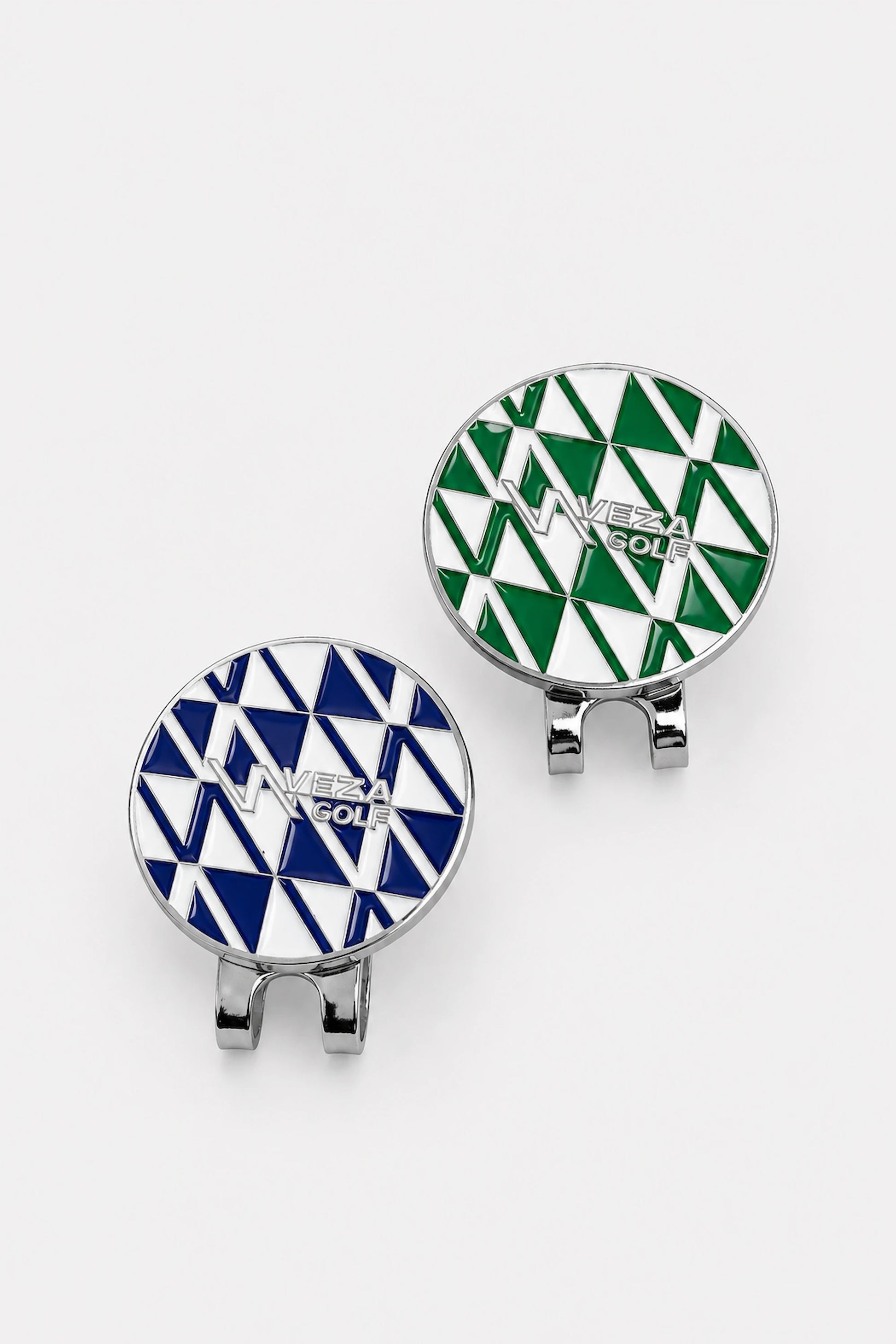 Geometric magnetic hat clips in blue and green with polished silver finish on light gray background