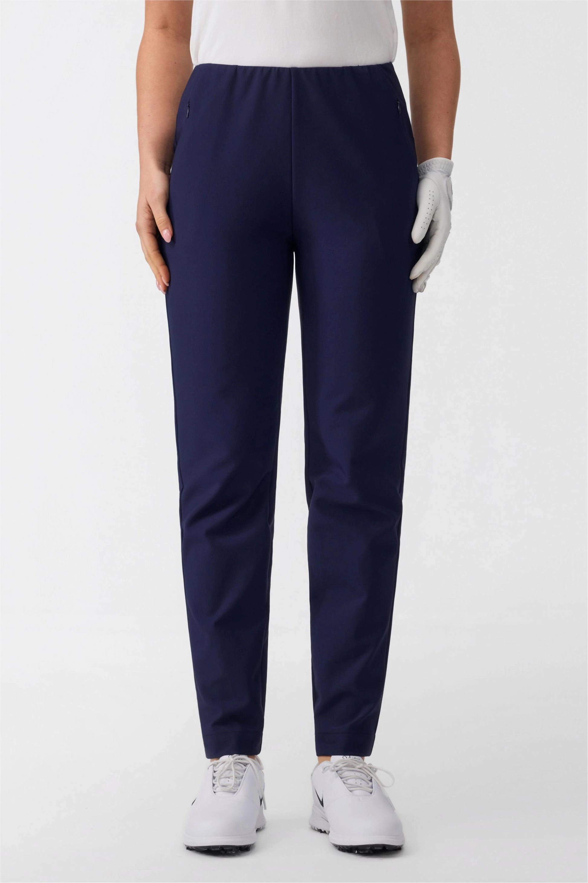 Close-up front view of midnight navy women’s golf pants highlighting clean tailored silhouette