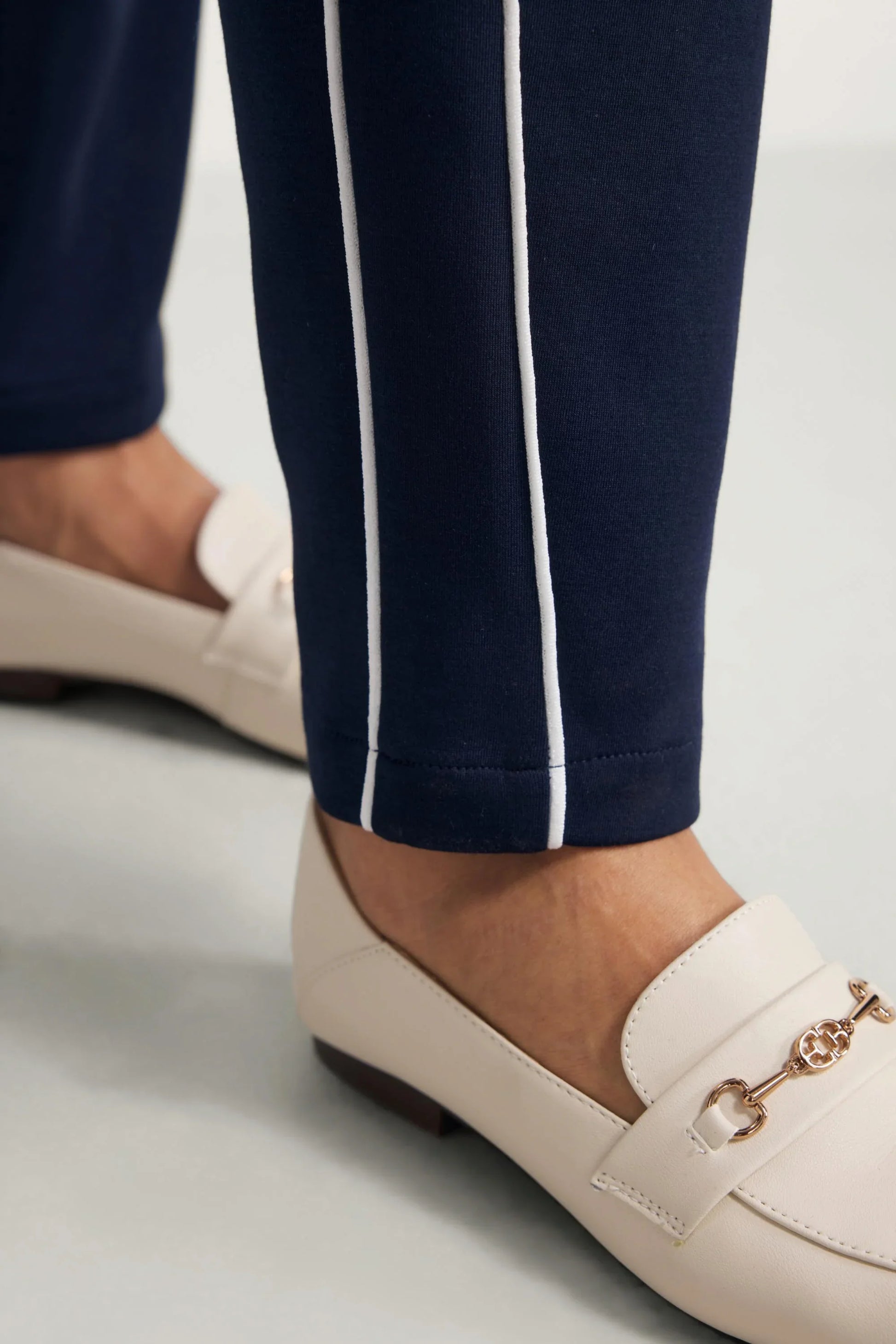 Close-up of the hem and contrast piping detail on Midnight Navy golf pants