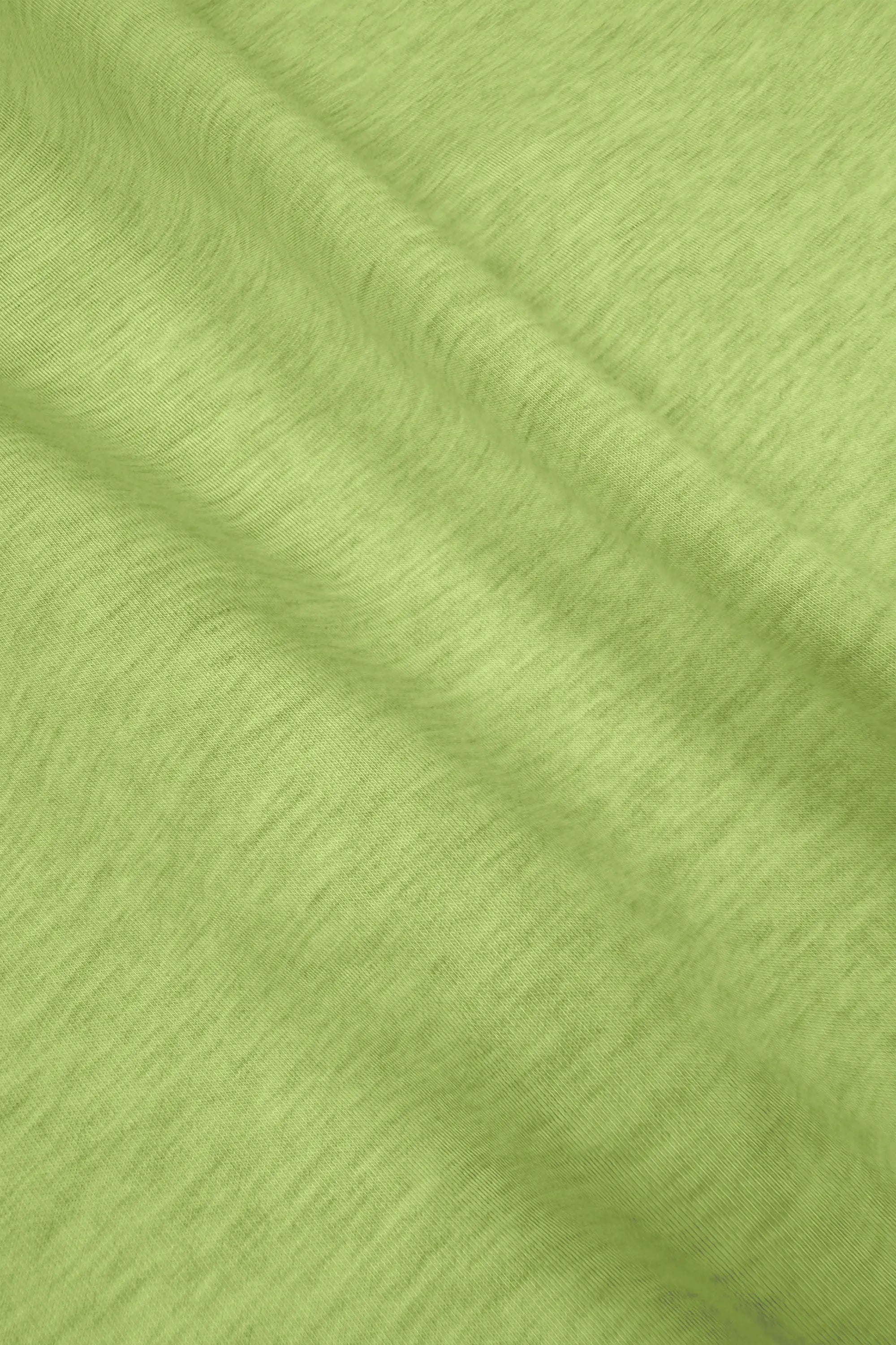 Close-up of lime Sculpt Wrap Golf Skort showing the soft stretch fabric texture and drape