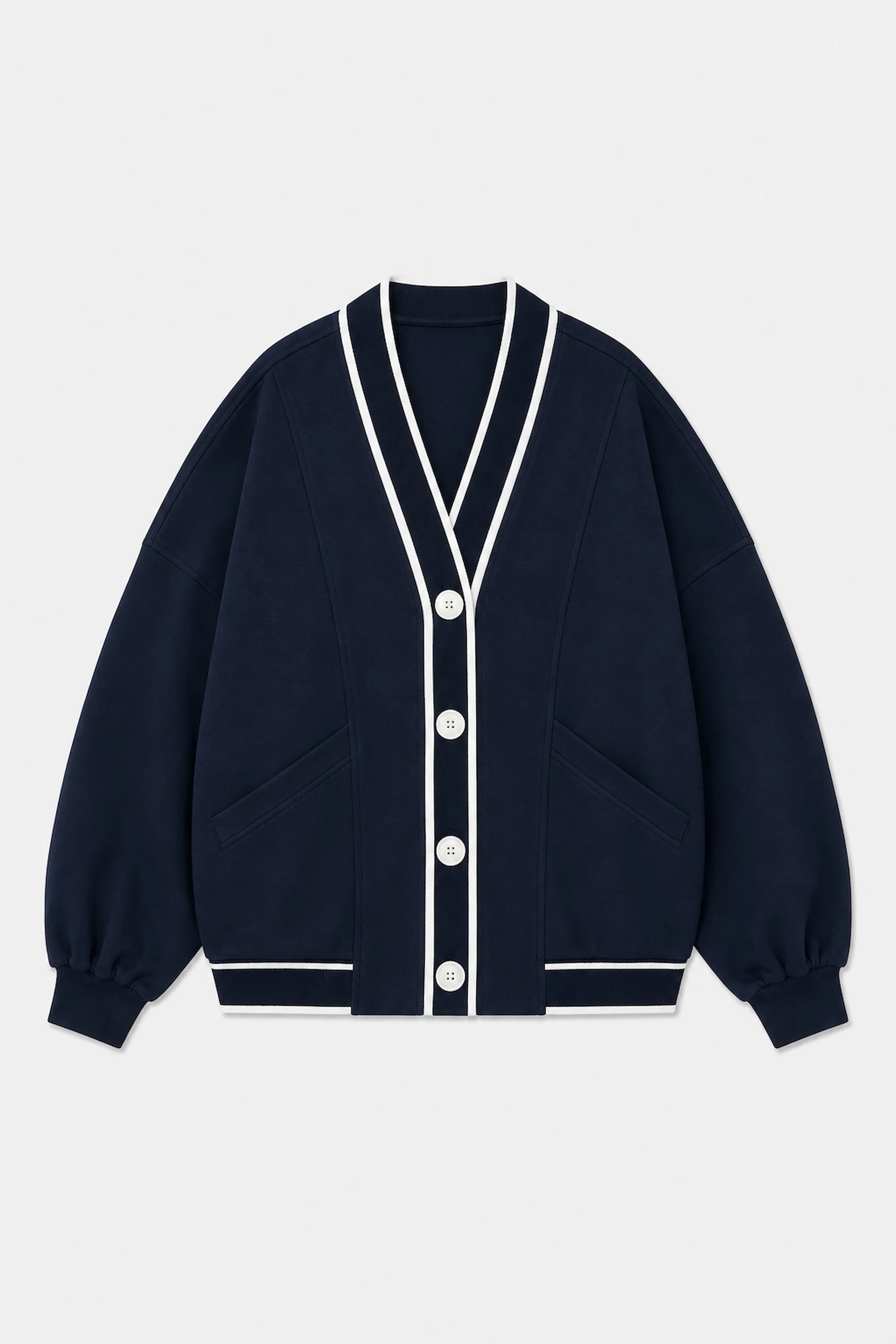 Front flat lay of Tailored Sports Cardigan in Midnight Navy featuring contrast white trim, button front, and patch pockets