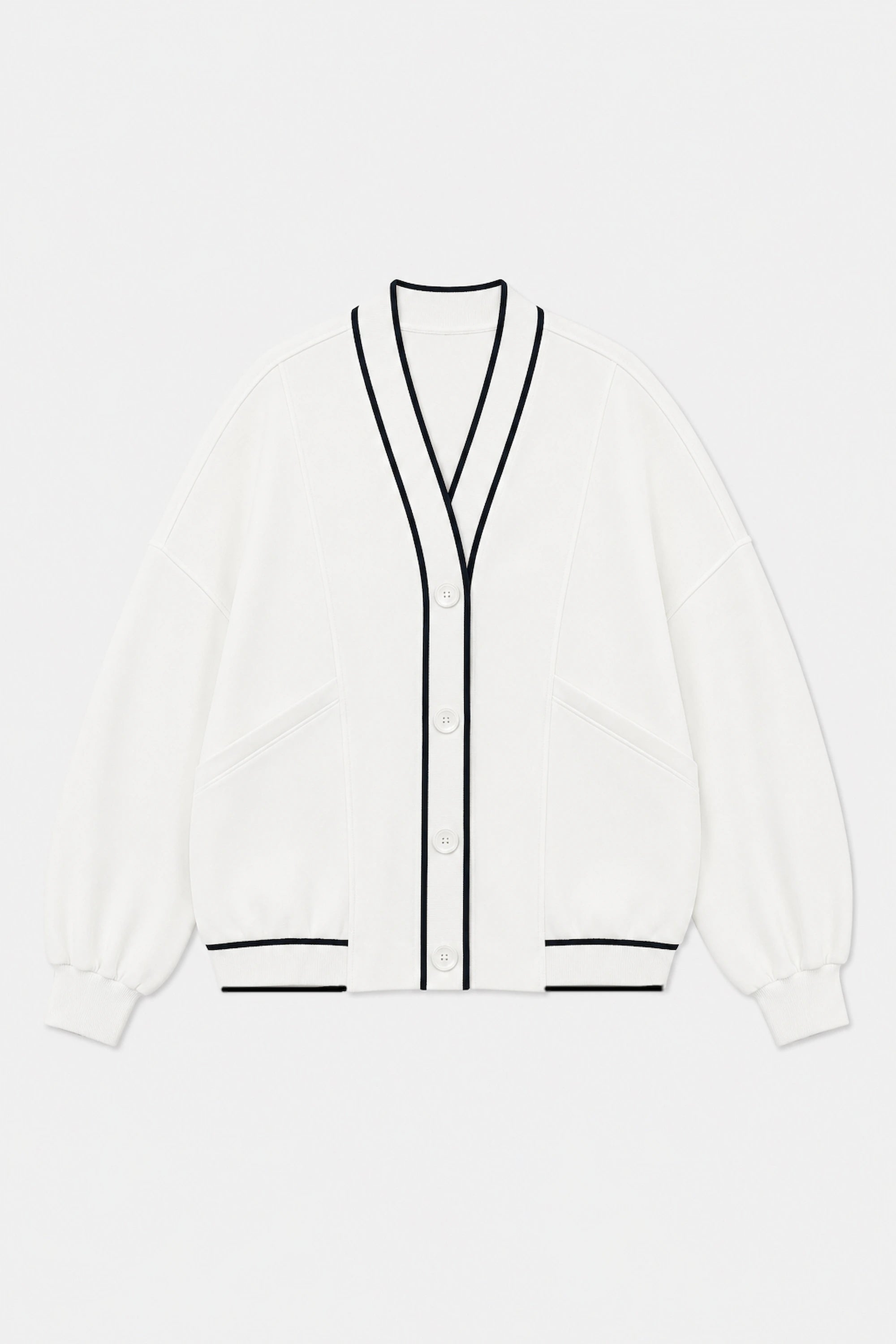 Front flat lay of Tailored Sports Cardigan in Soft Ivory featuring contrast black trim, button front, and patch pockets