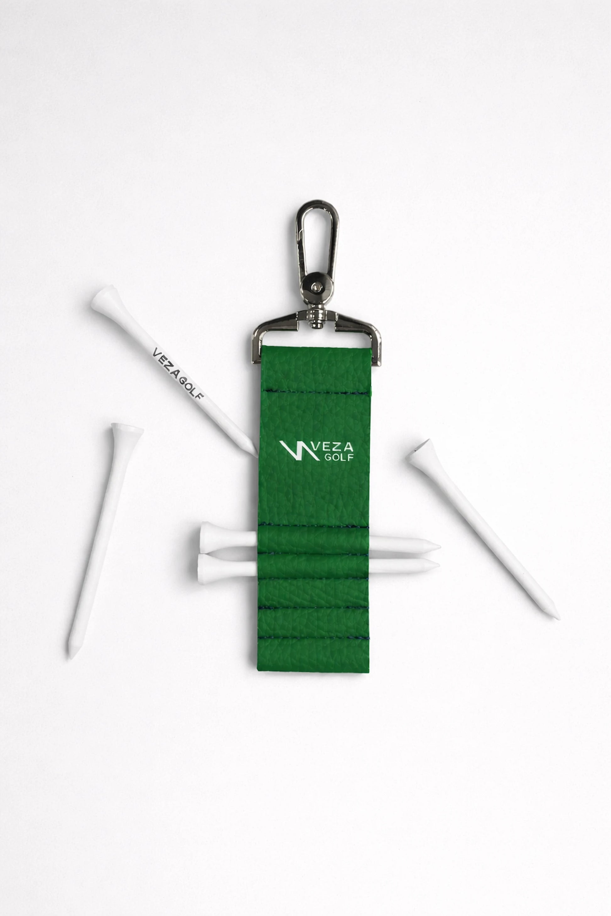 Close-up of VEZA green golf tee holder clip holding several golf tees