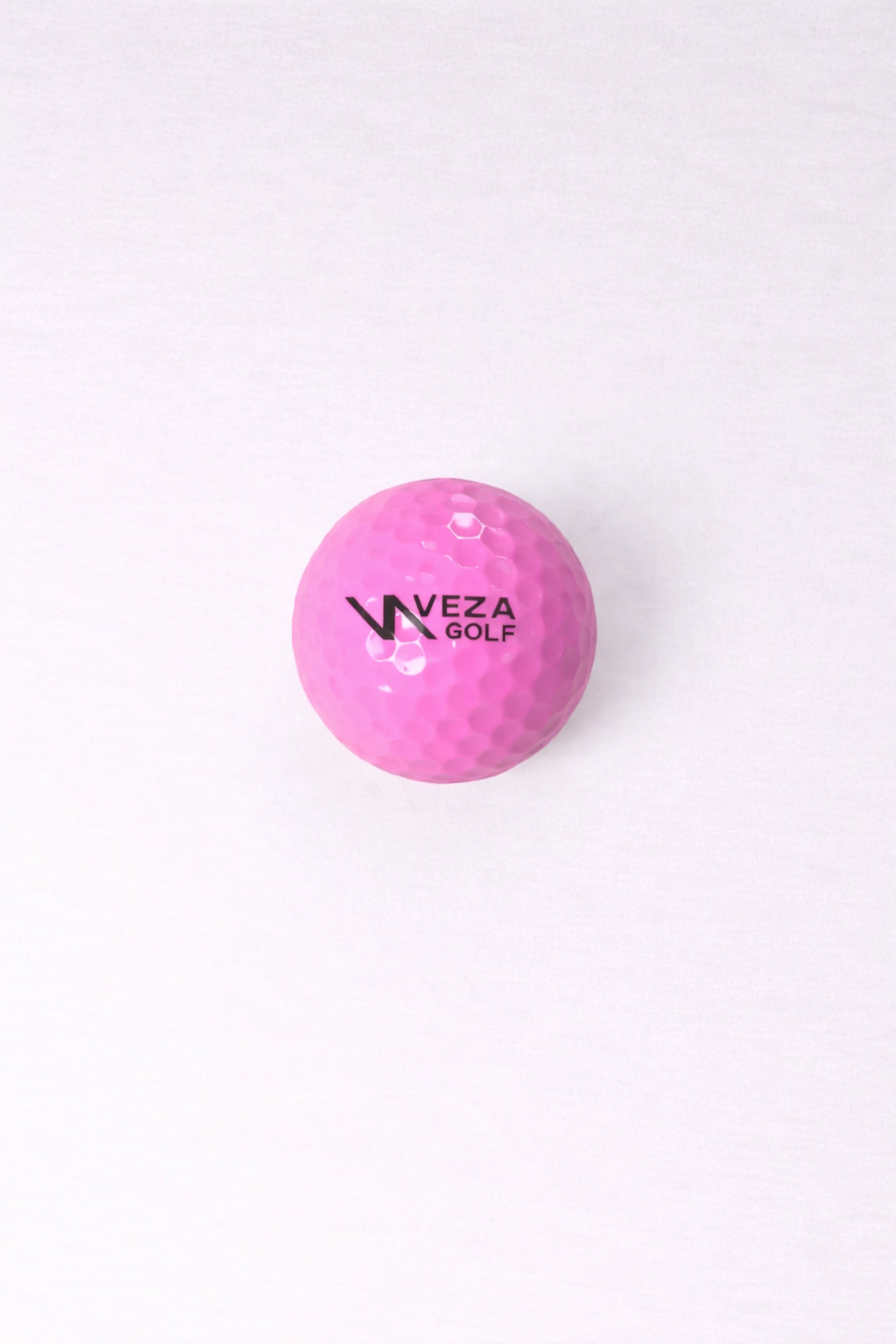 Pink VEZA surlyn golf ball with brand logo