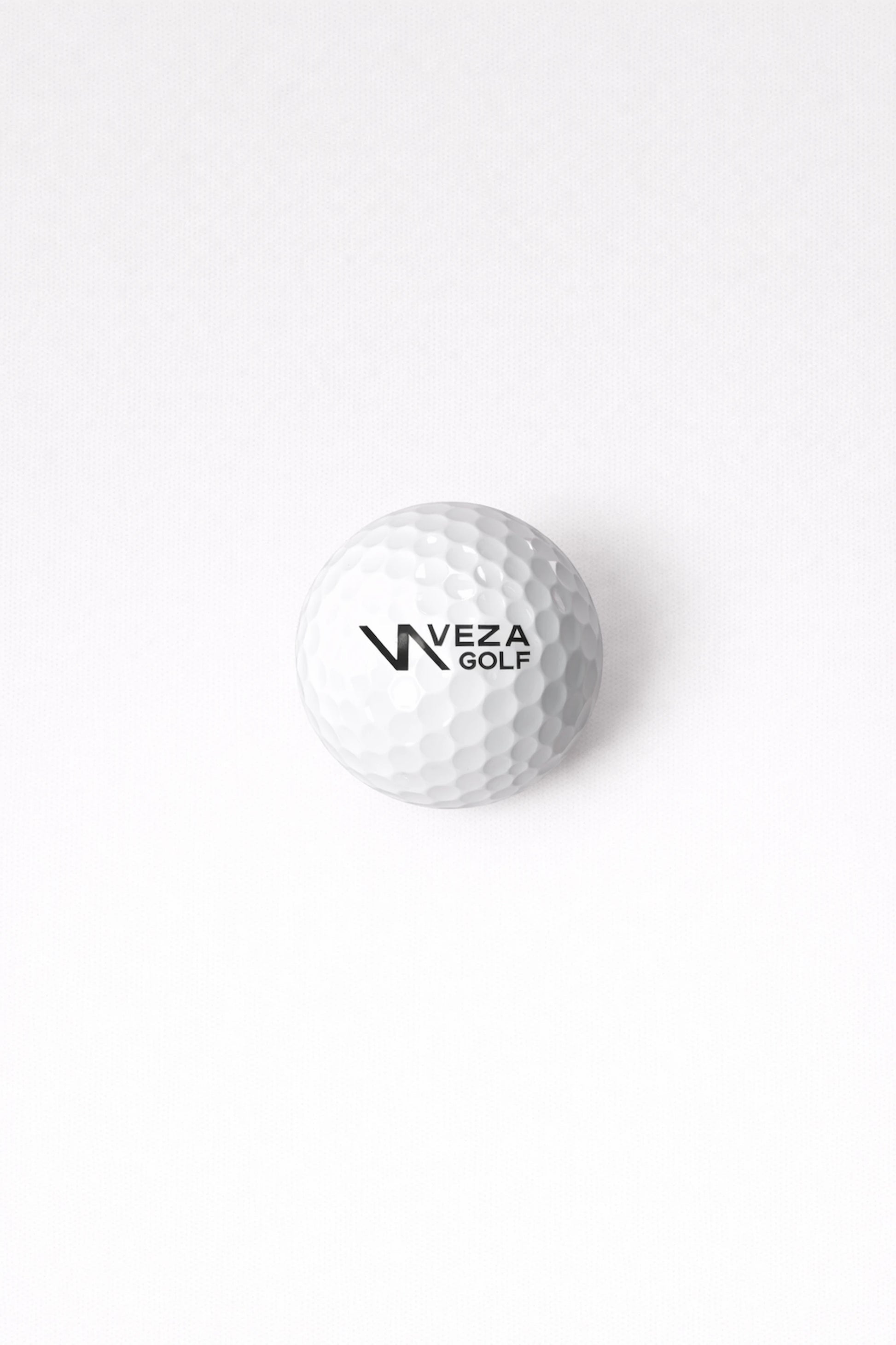 White VEZA surlyn golf ball with logo on clean background