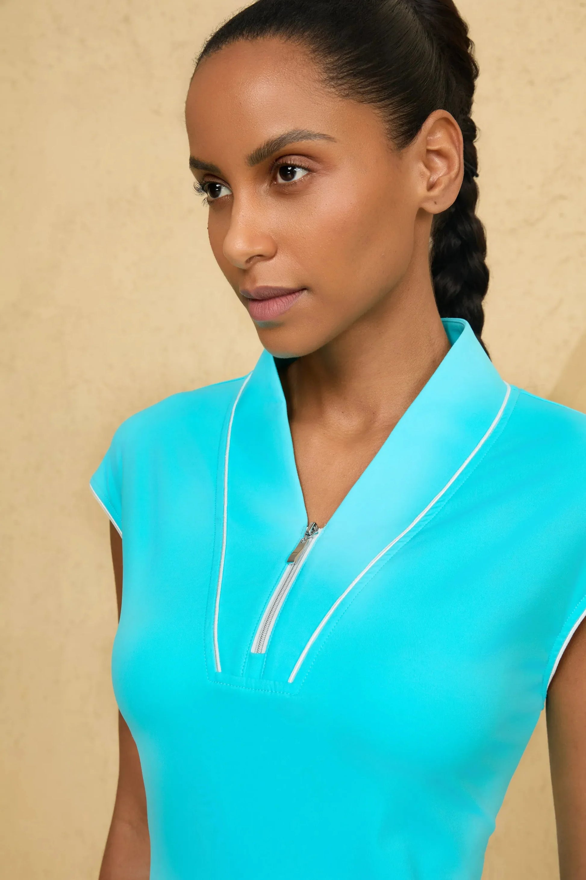 Close-up of VEZA skyserve blue cap sleeve zip-front golf dress showcasing the sculpting piping and zip neckline