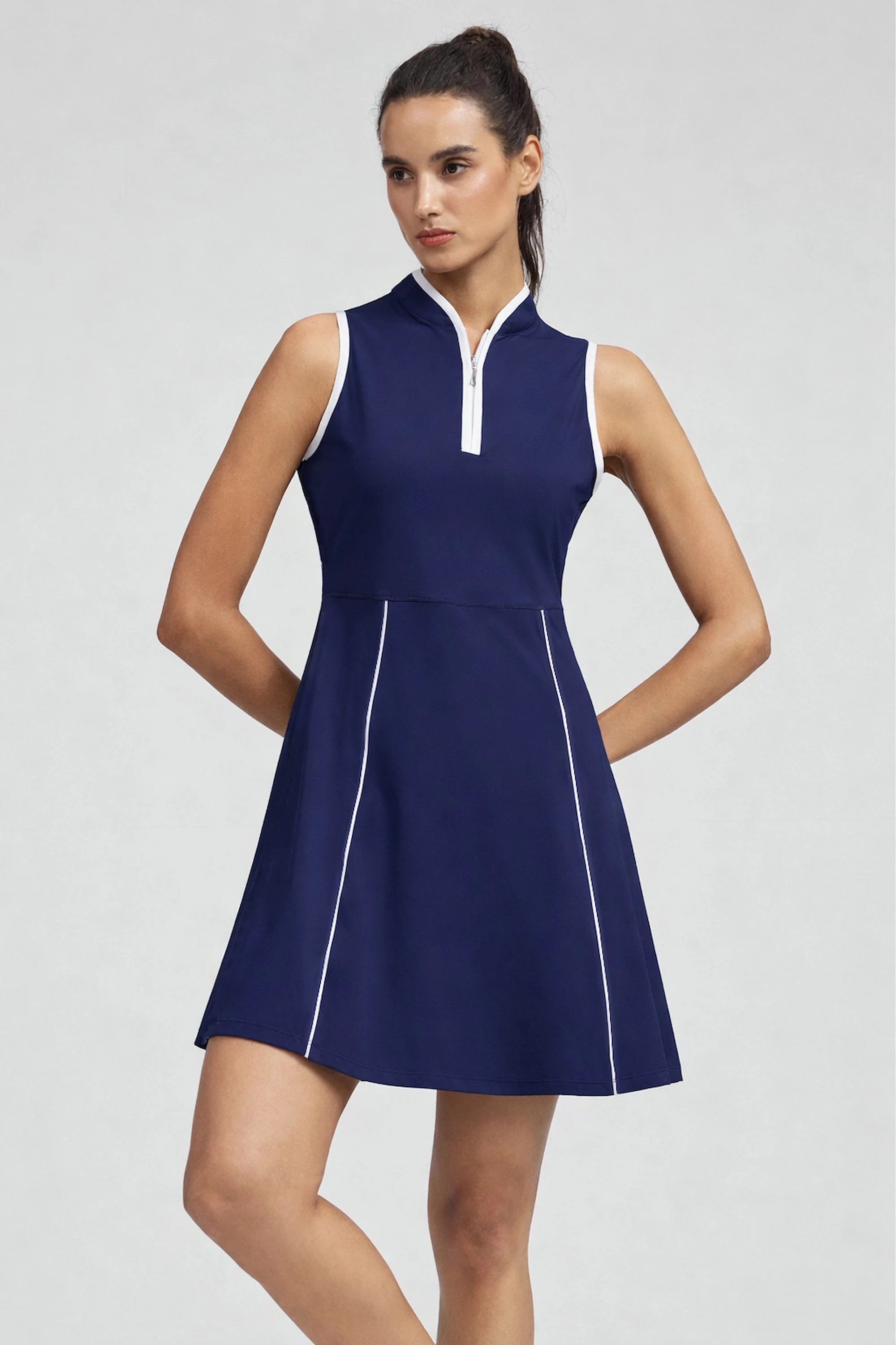 Woman wearing VEZA midnight swing navy blue sleeveless half-zip golf dress with UPF 50+, front view
