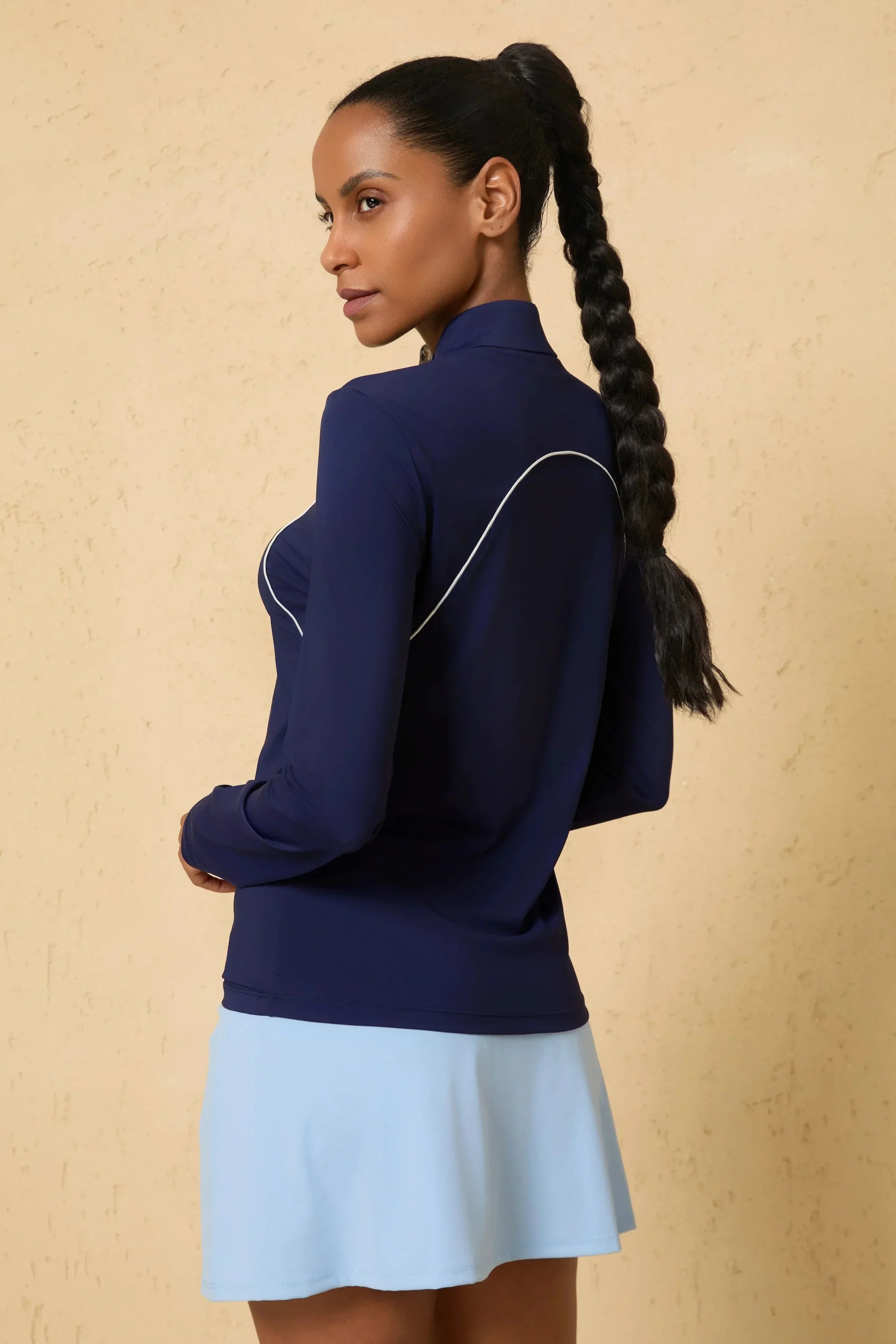 Side view of VEZA midnight swing navy blue quarter-zip performance top featuring stretch fabric for active movement