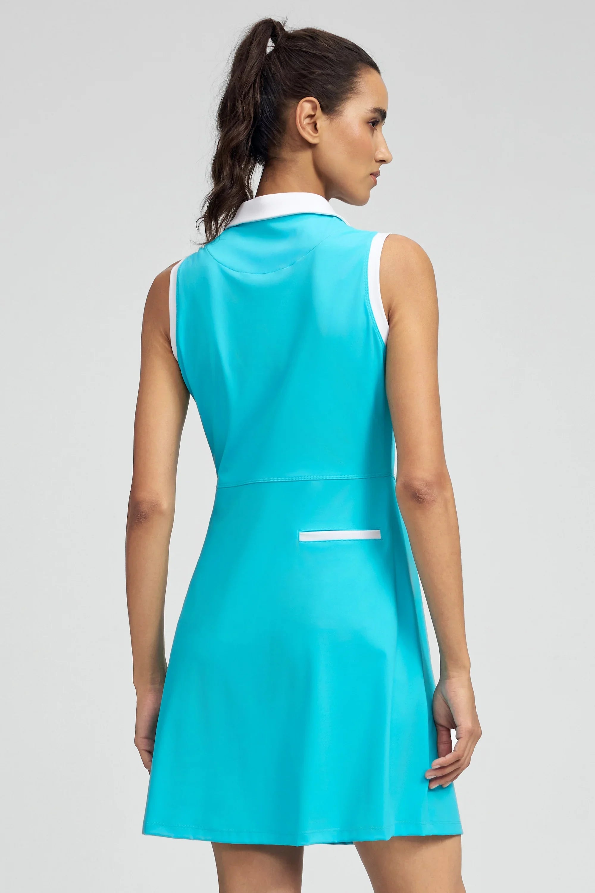 Back view of VEZA skyserve blue sleeveless performance golf dress with a clean, athletic silhouette