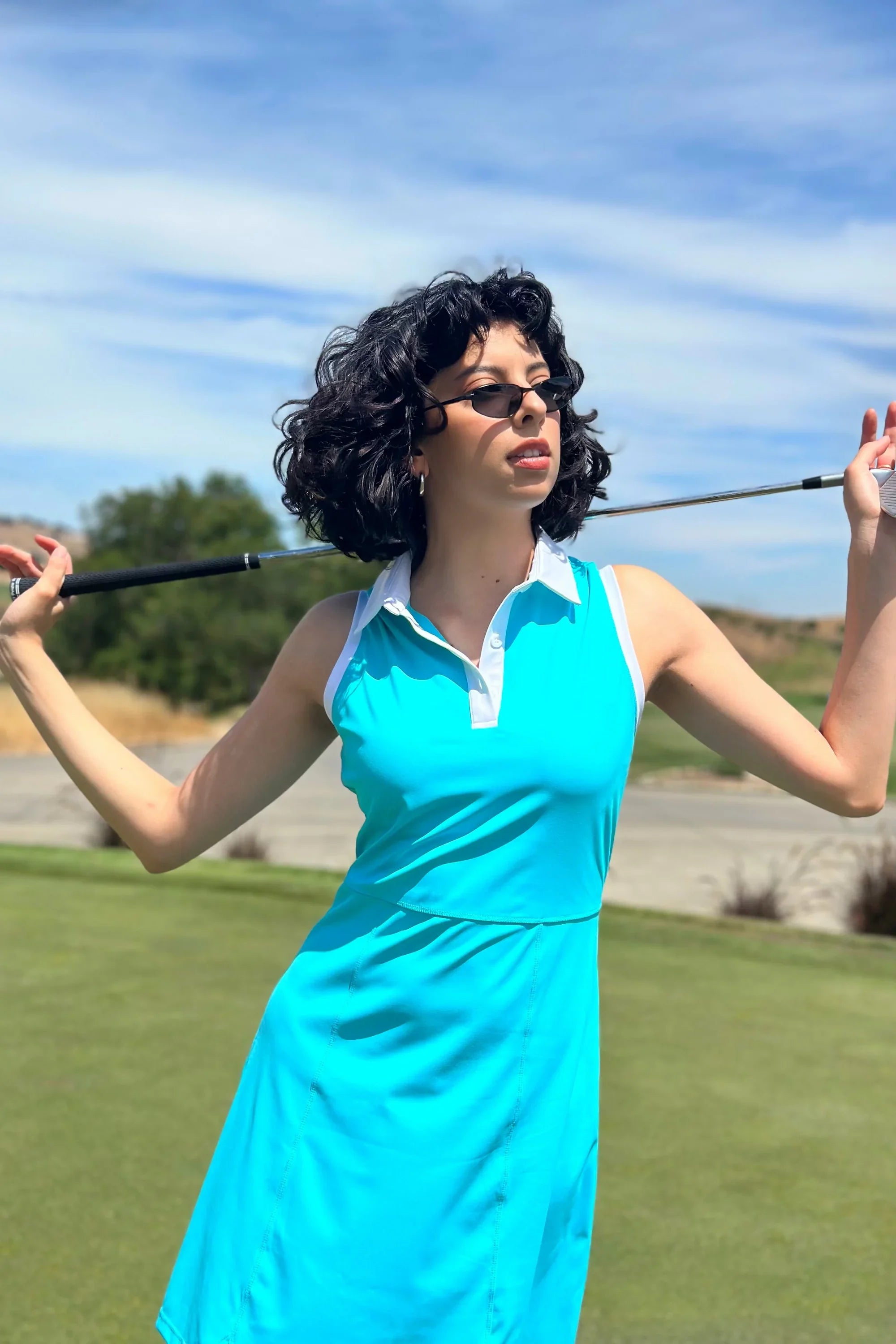 VEZA skyserve blue sleeveless performance golf dress worn on the course, designed for lightweight, breathable movement
