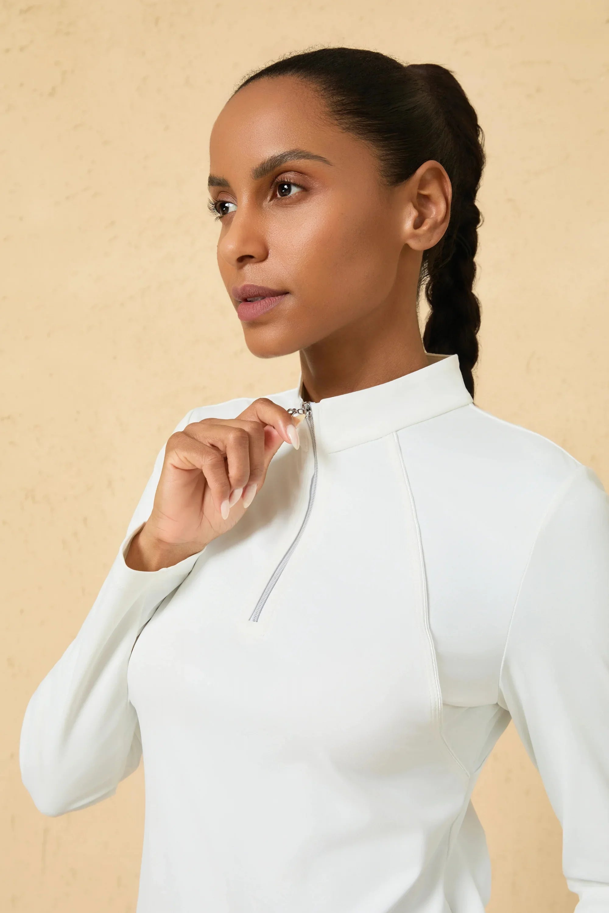 Close-up of quarter-zip collar detail on a women’s white UPF 50+ performance golf top