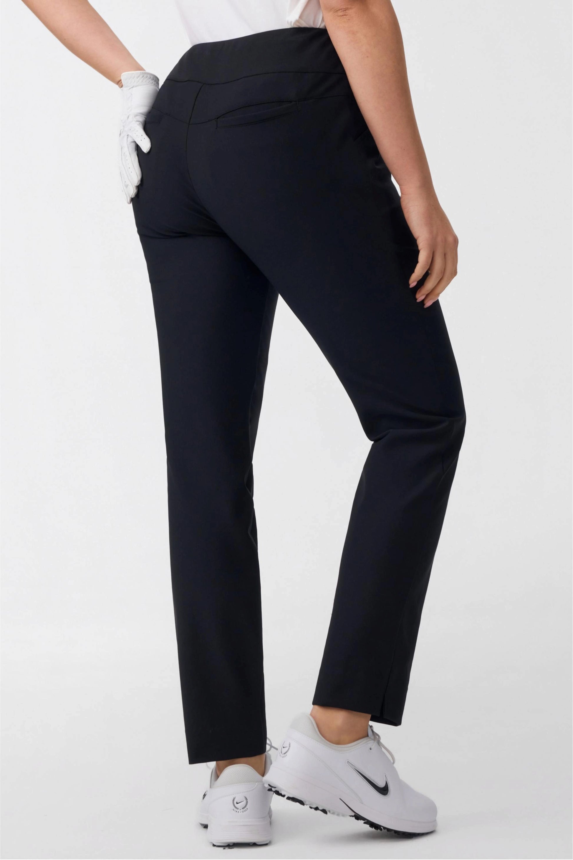 Back view of women’s onyx black tapered golf pants showing rear pocket detail