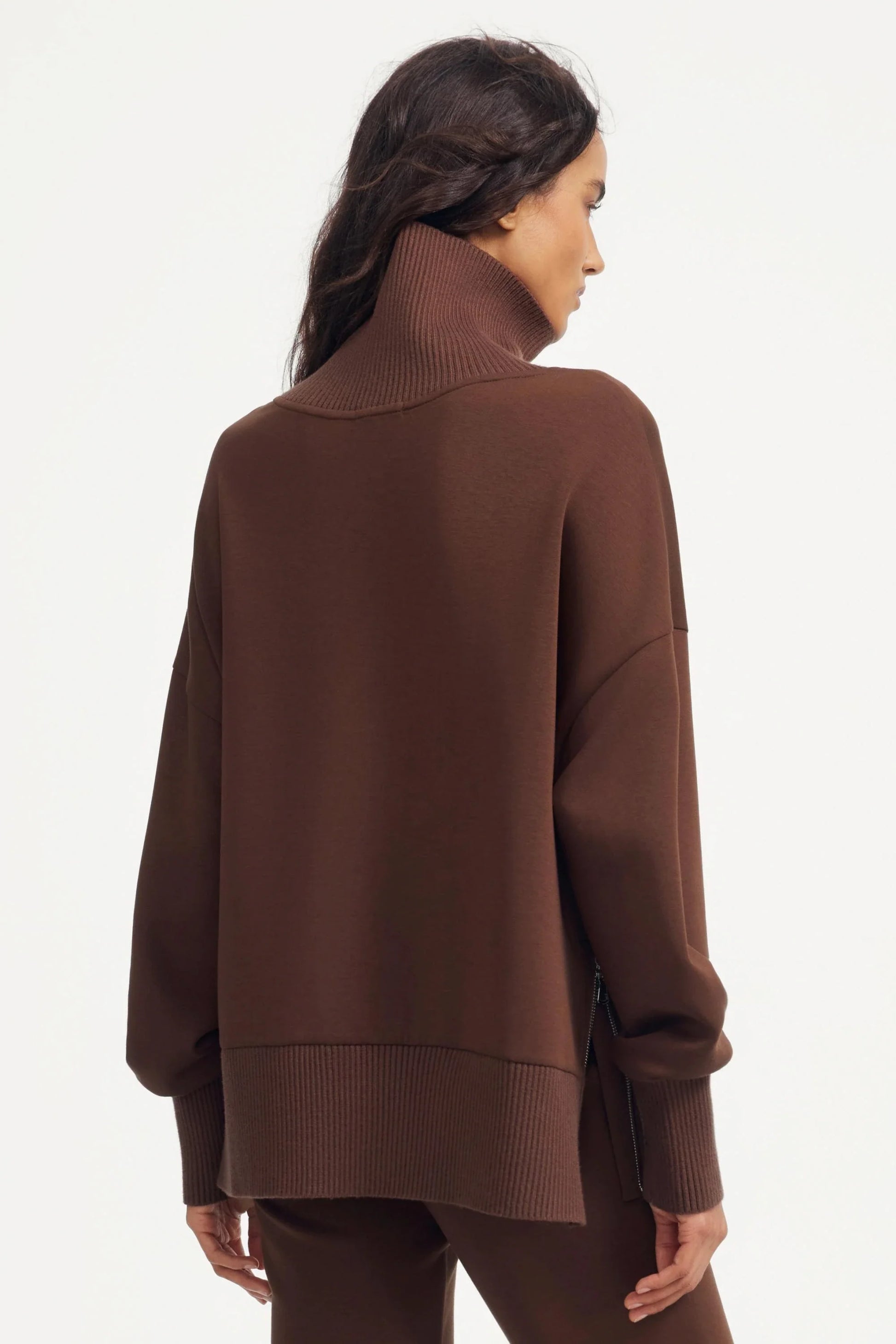 Back view of women’s brown funnel-neck pullover with relaxed silhouette