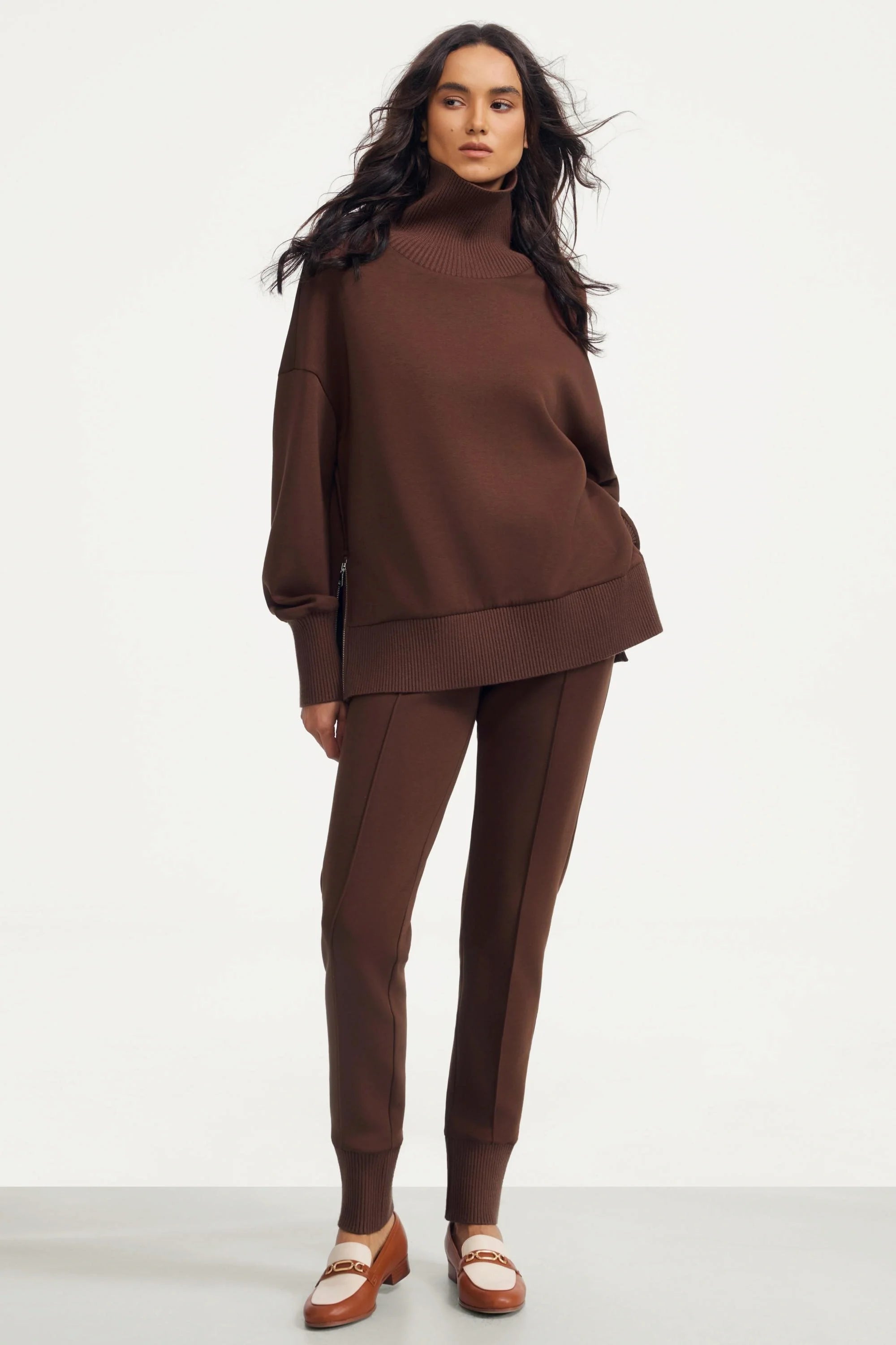 Women’s brown funnel-neck pullover styled with matching slim-fit pants