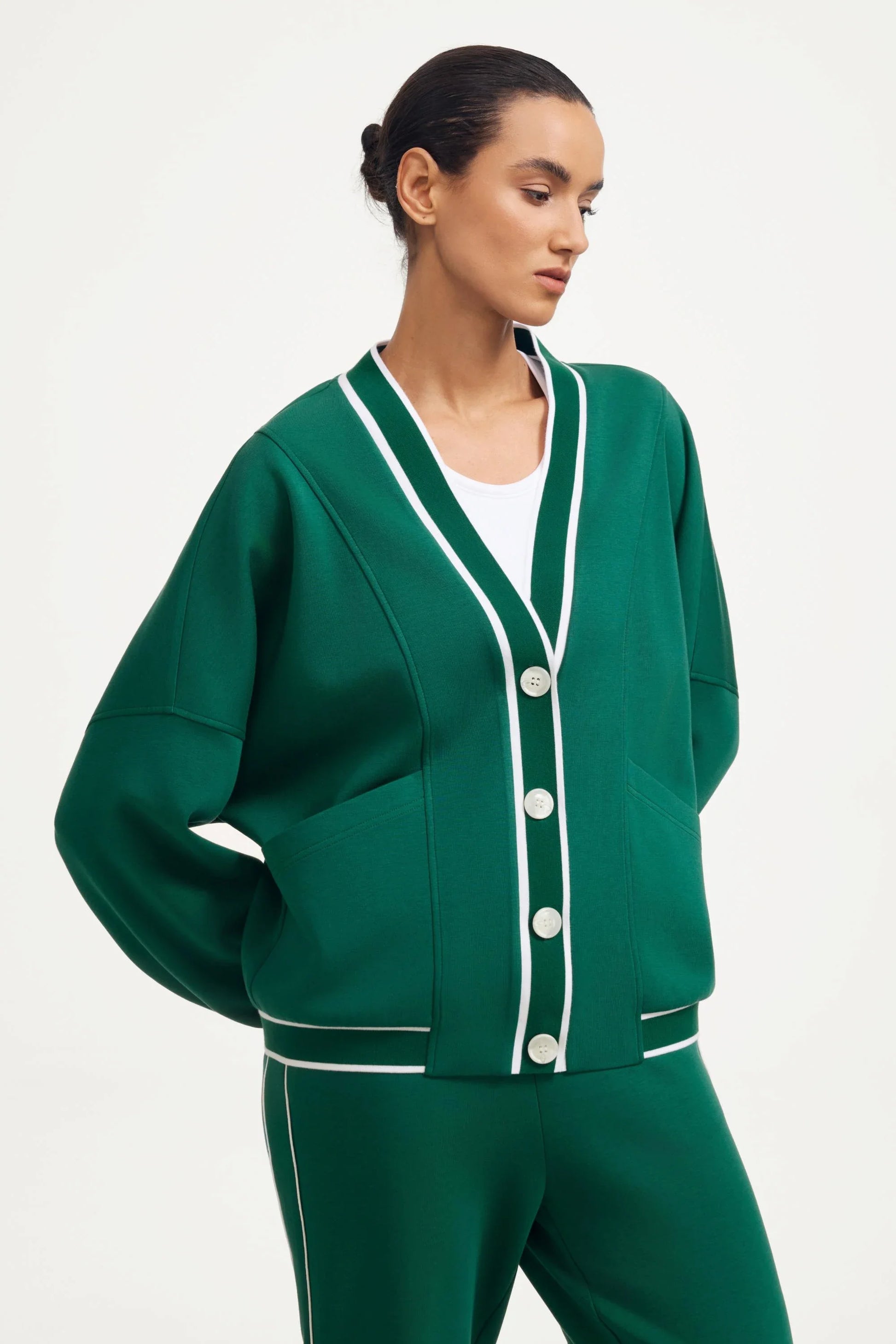 Women’s button cardigan in deep teal with contrast trim and a clean V-neck front