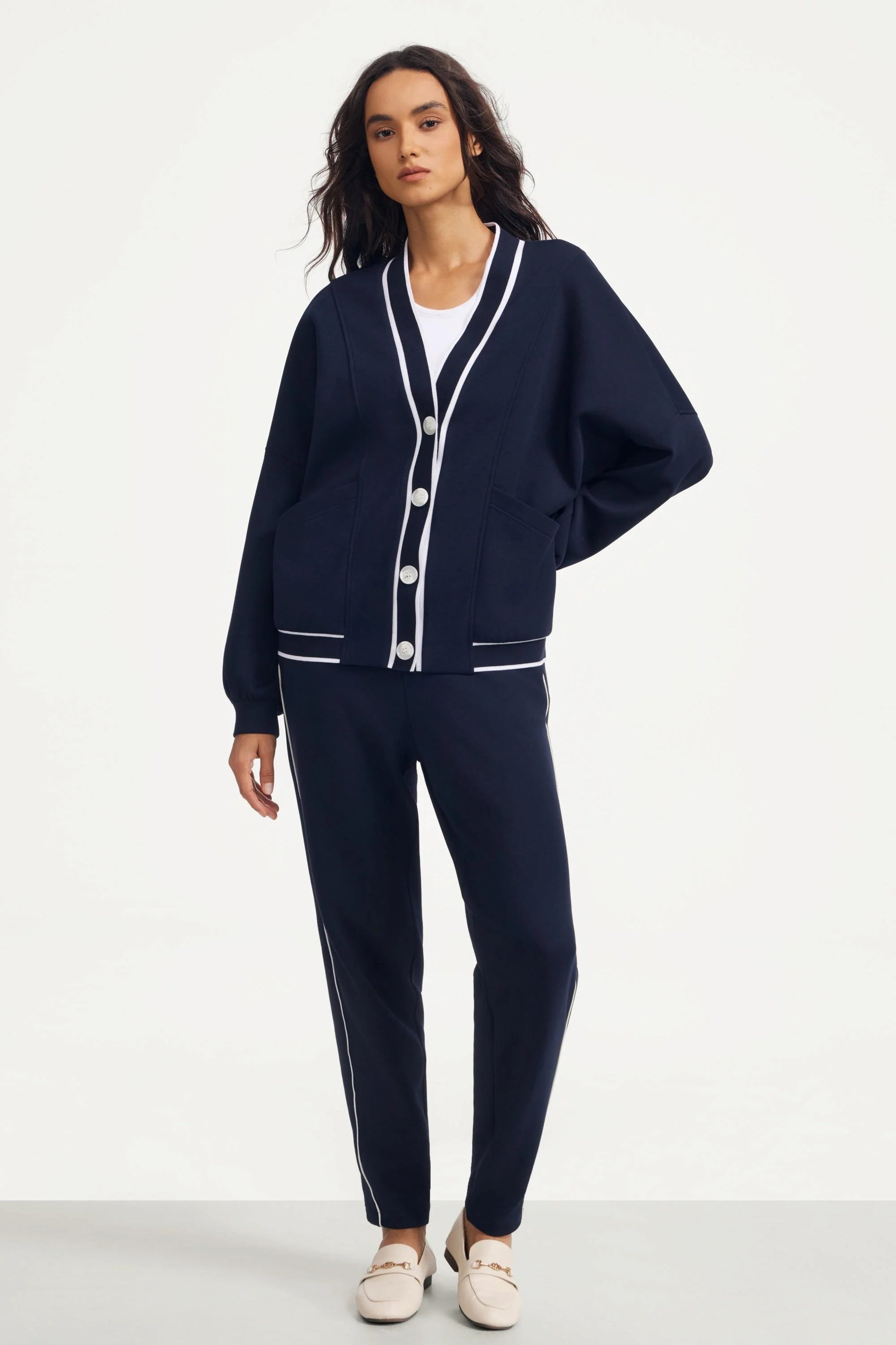Full look of a woman wearing a midnight navy button cardigan with matching pants