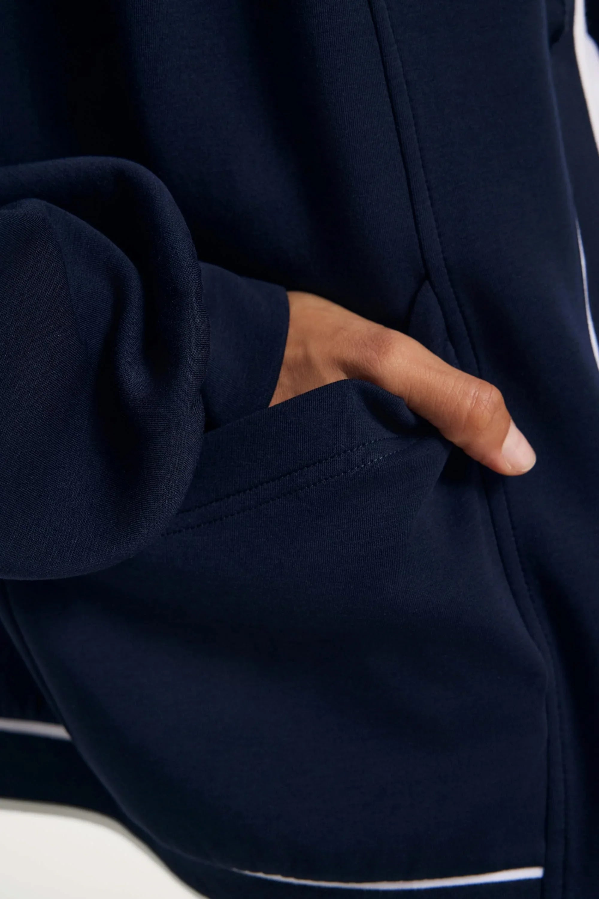 Pocket detail on a midnight navy women’s button cardigan