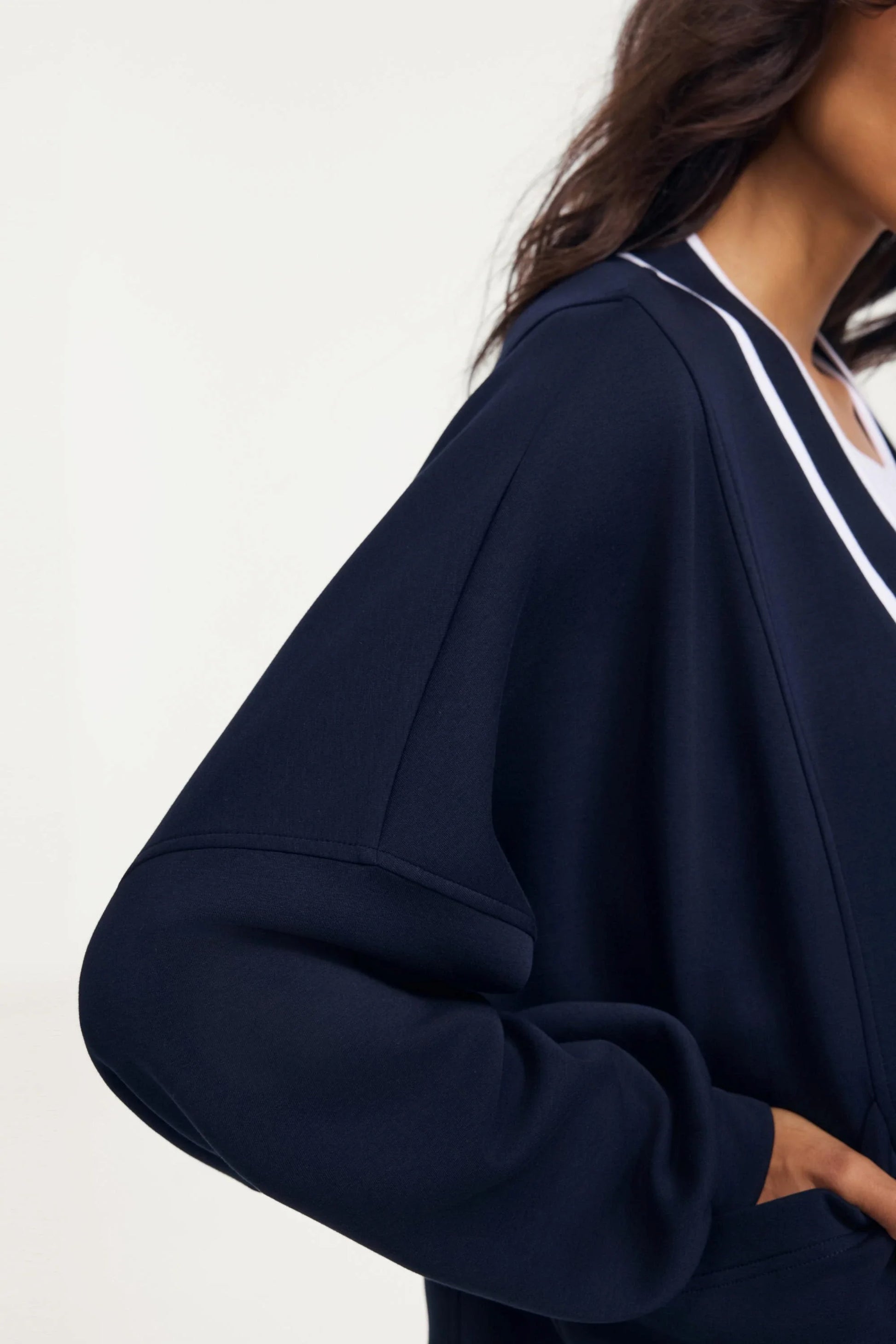 Detail of the sleeve shape on a midnight navy women’s button cardigan