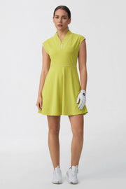 Woman wearing a citron yellow cap sleeve zip-front golf dress with contrast piping