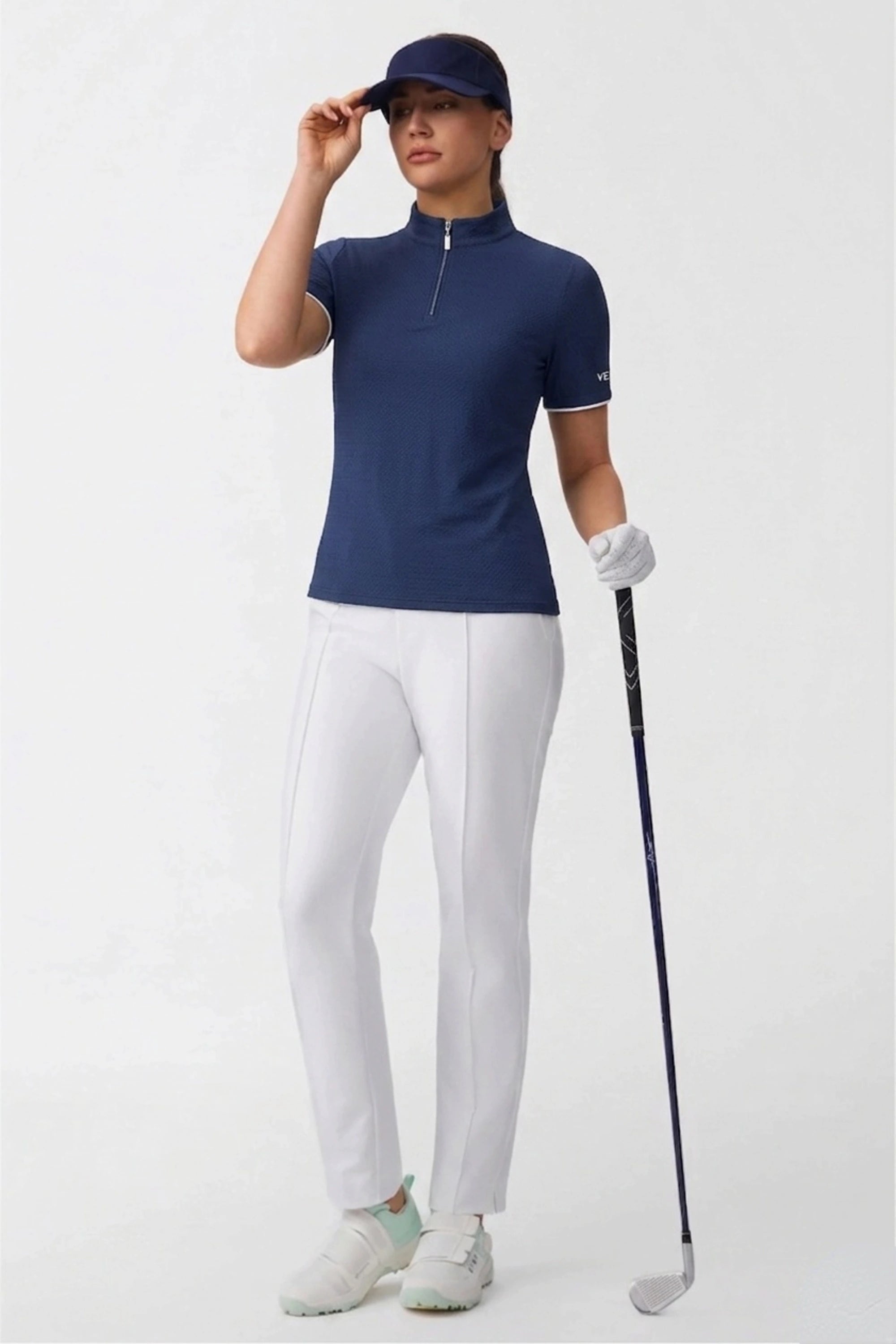 Women’s navy zip-neck golf top with a fitted contour silhouette, short sleeves, and performance golf design