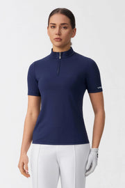 Model wearing a navy zip neck golf top with a streamlined athletic fit