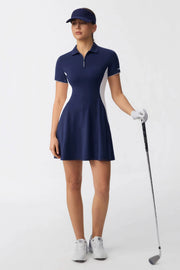 Women’s navy contour zip polo golf dress worn by a model holding a golf club, featuring a sculpted fit and sporty zip polo neckline