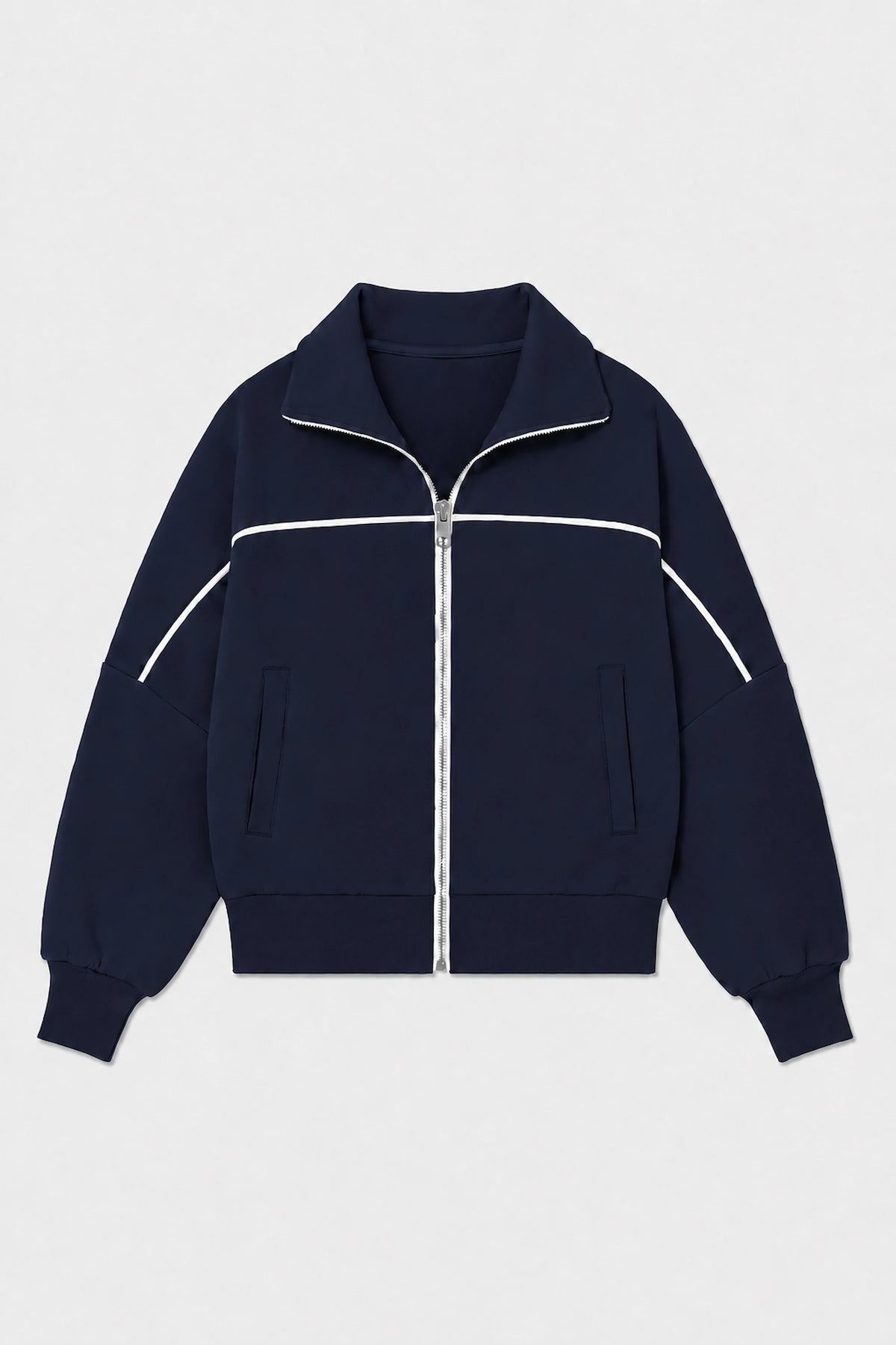 Front flat lay of women’s Midnight Navy cropped golf jacket featuring contrast white piping, full-zip front, and side pockets