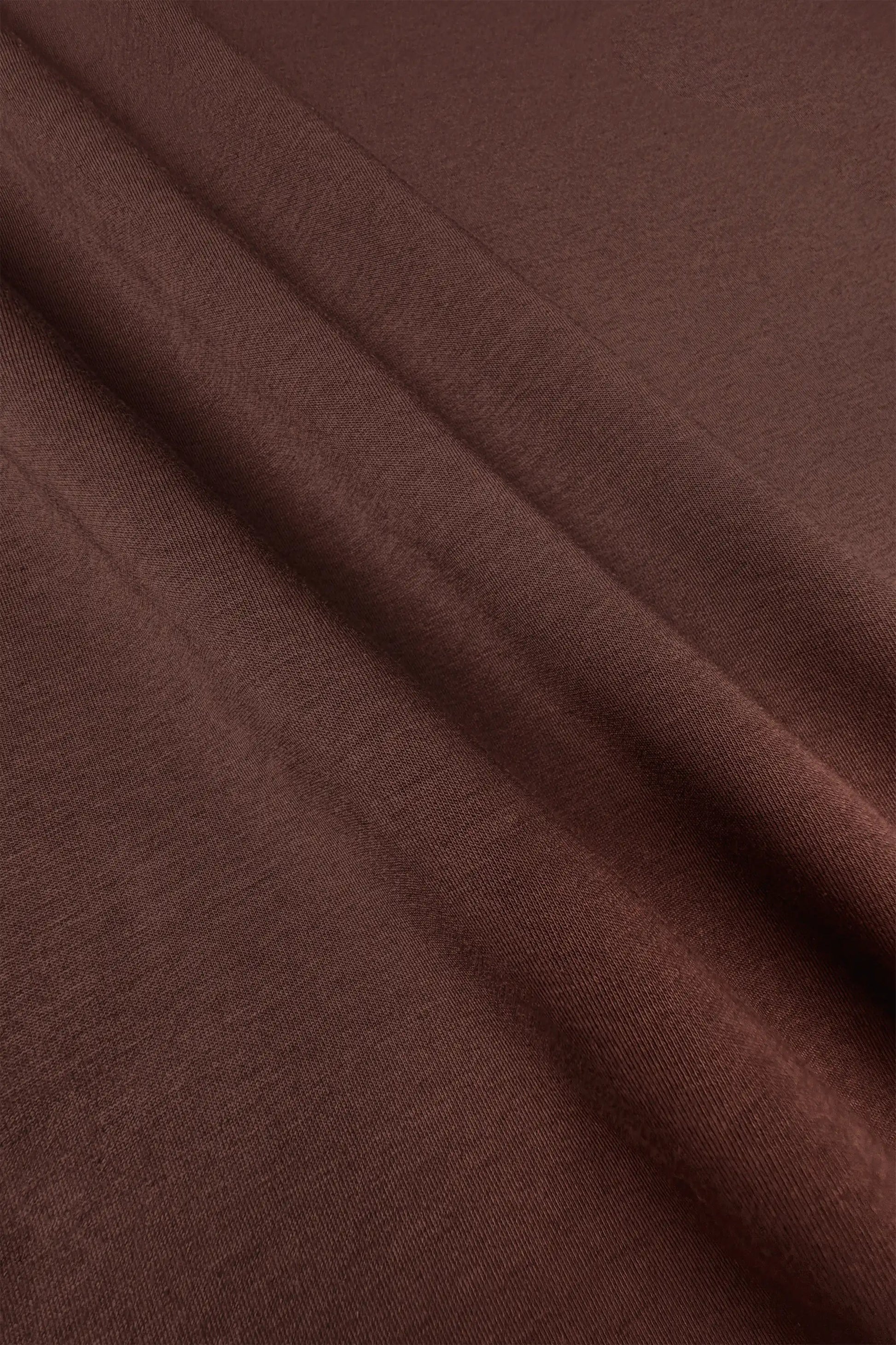 Close-up of the soft brown fabric texture on the women’s drawstring jogger pants