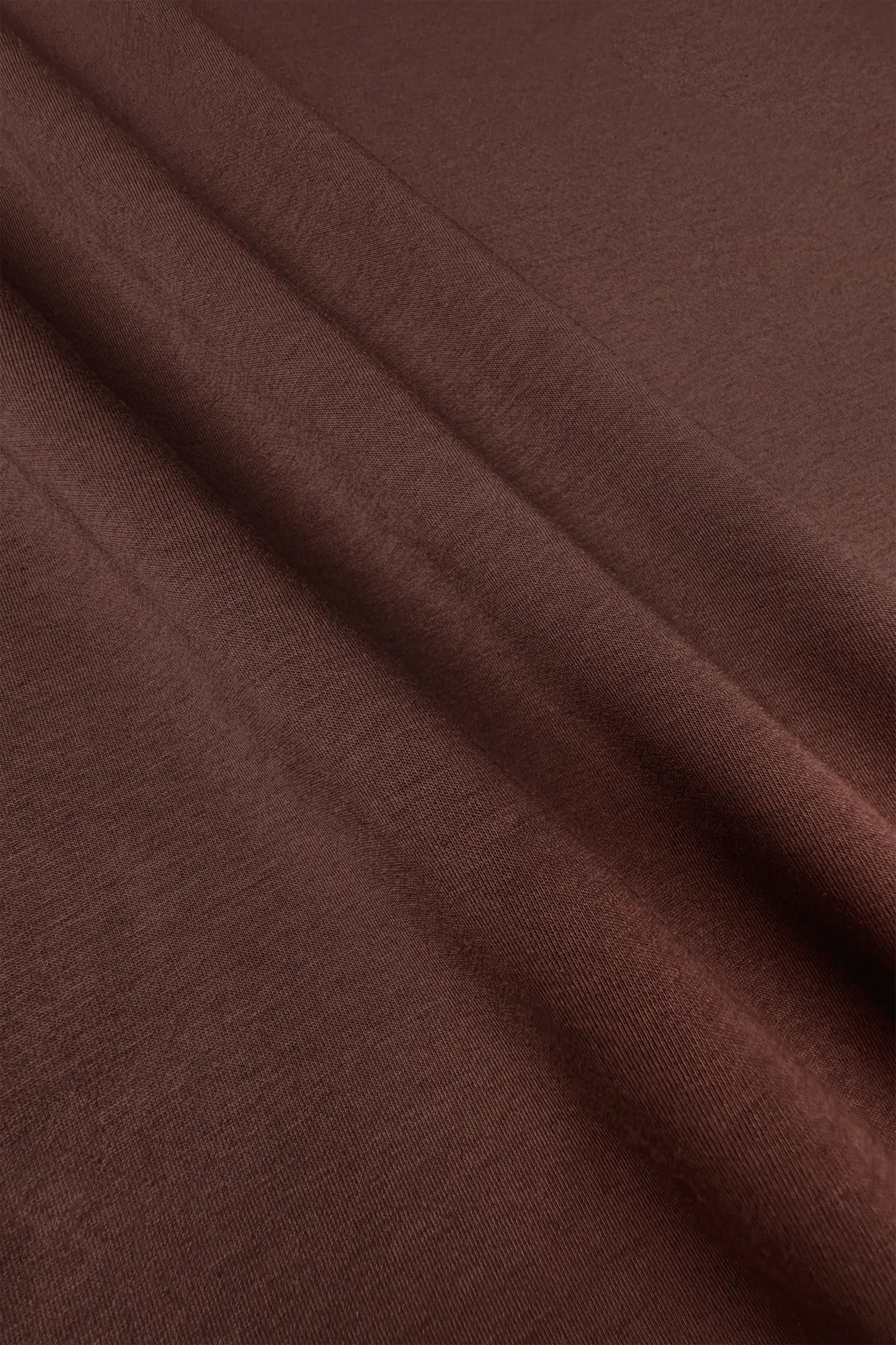 Close-up of the soft brown fabric texture on the women’s drawstring jogger pants