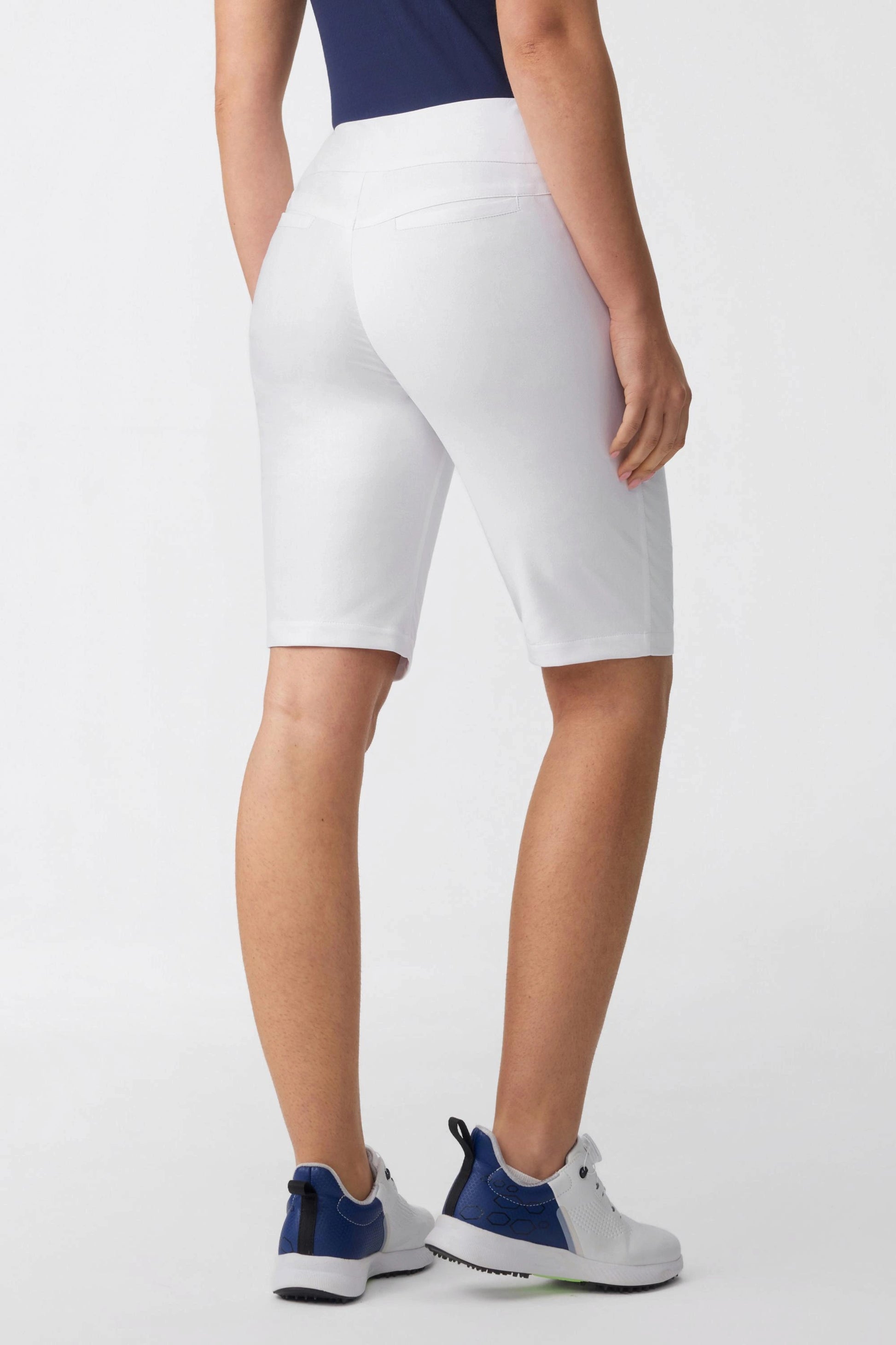 Back angled view of women’s cloudline tailored golf shorts with sculpted fit and back pocket detail