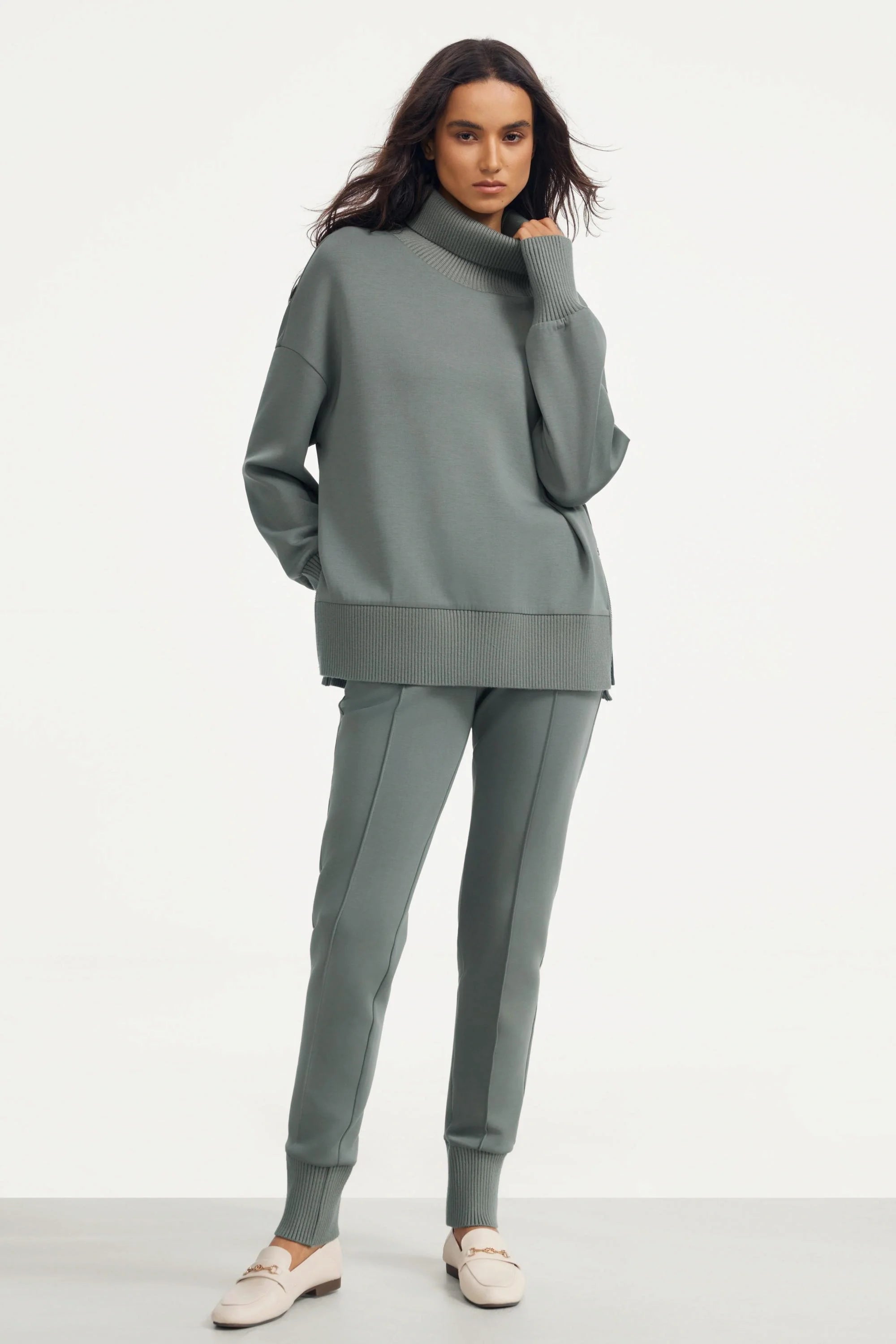 Women’s funnel-neck pullover in sage grey styled with matching jogger pants