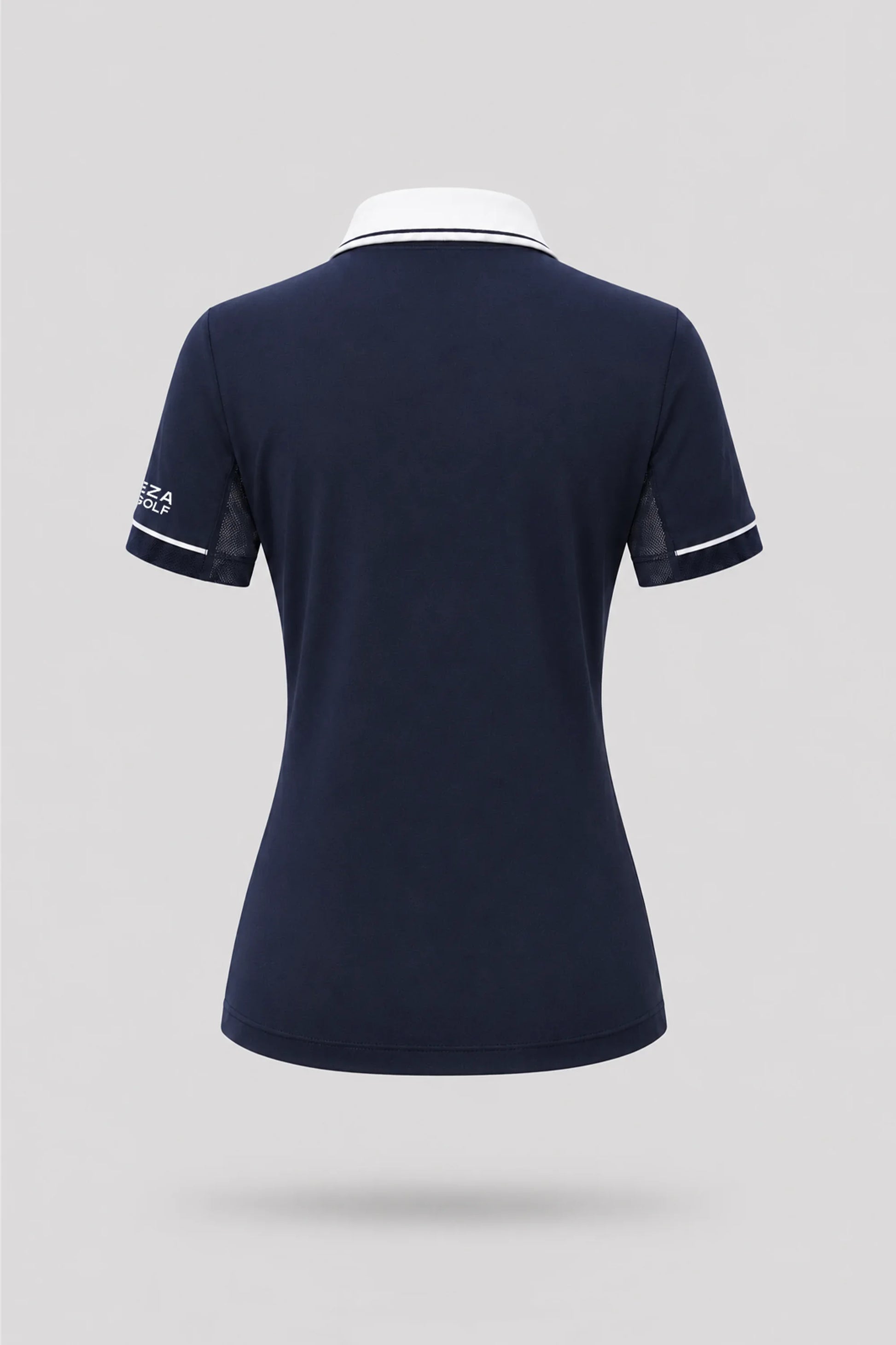 Back view of women's midnight navy golf polo with breathable mesh sleeve panels and athletic silhouette
