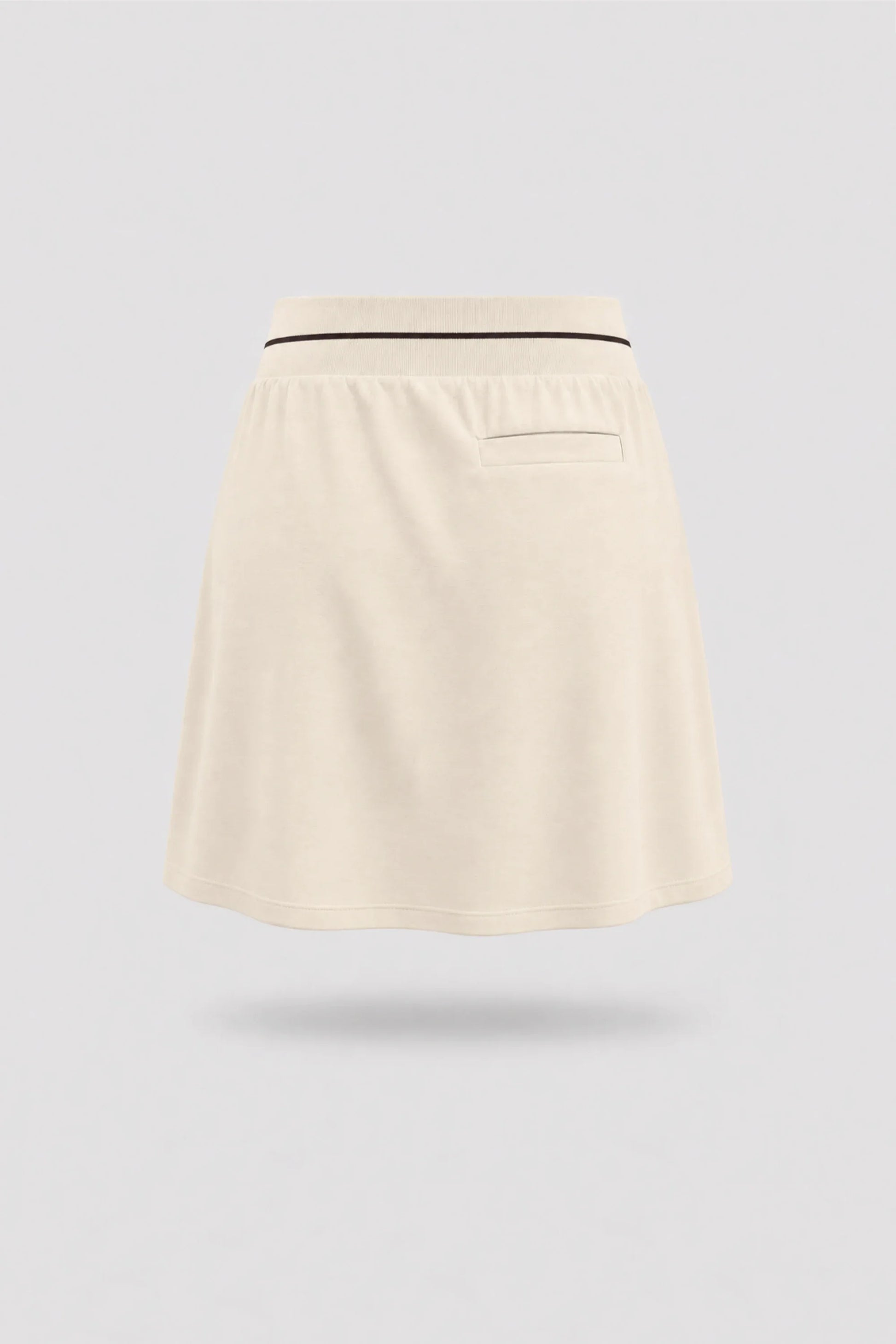 Back view of women's Cream golf skort with lightweight stretch performance fabric and athletic fit
