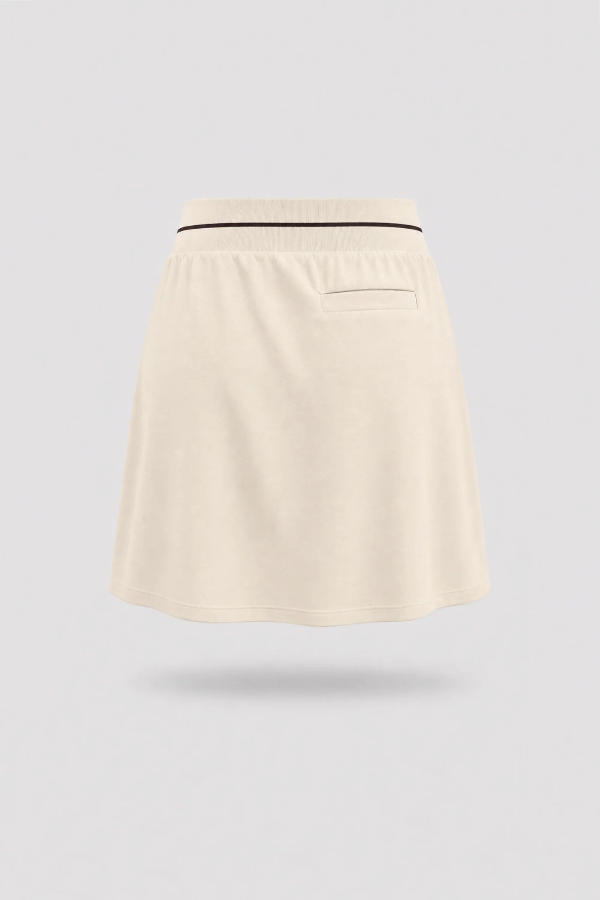 Back view of women's Cream golf skort with lightweight stretch performance fabric and athletic fit