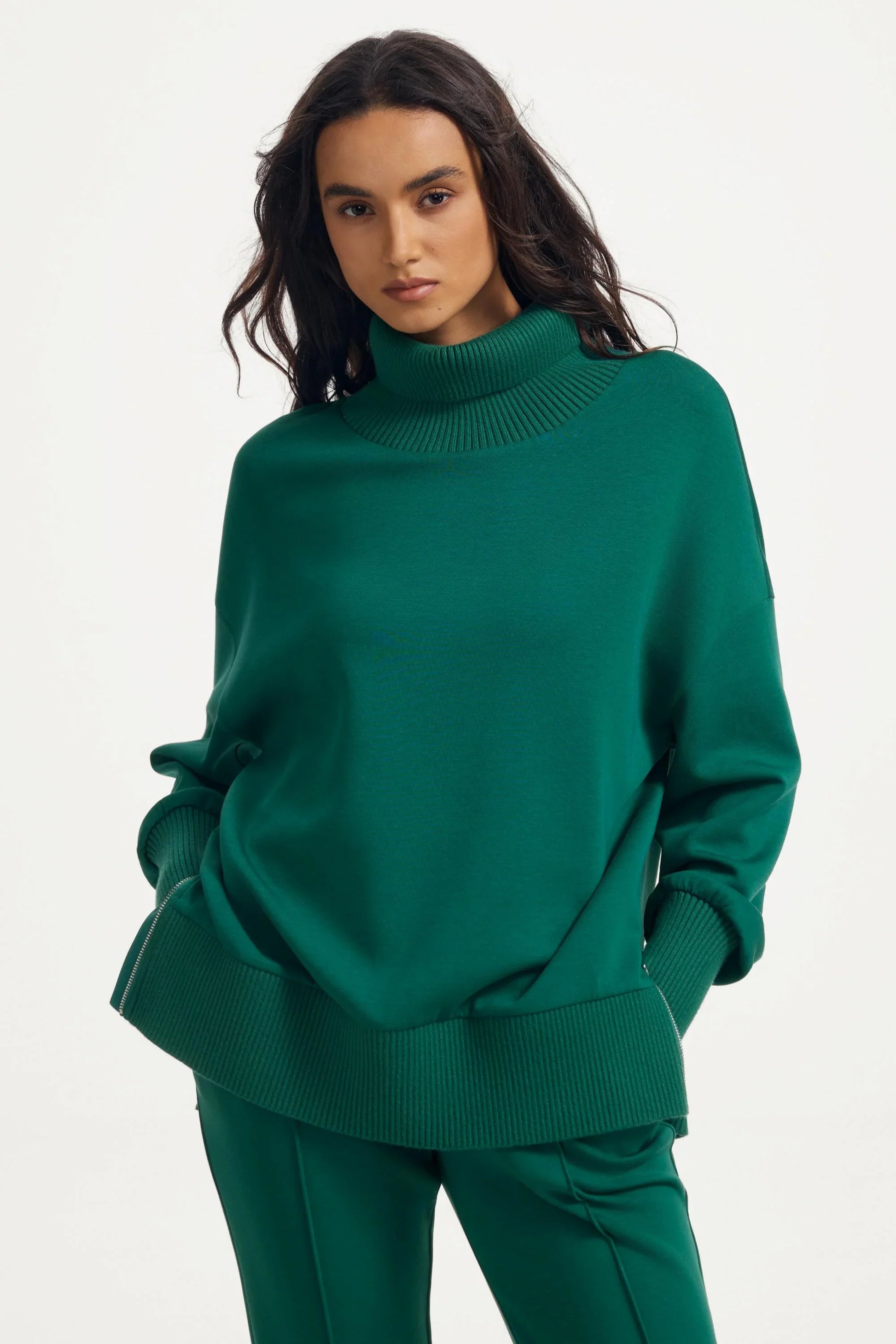 Women’s green funnel-neck pullover in deep teal with relaxed oversized fit