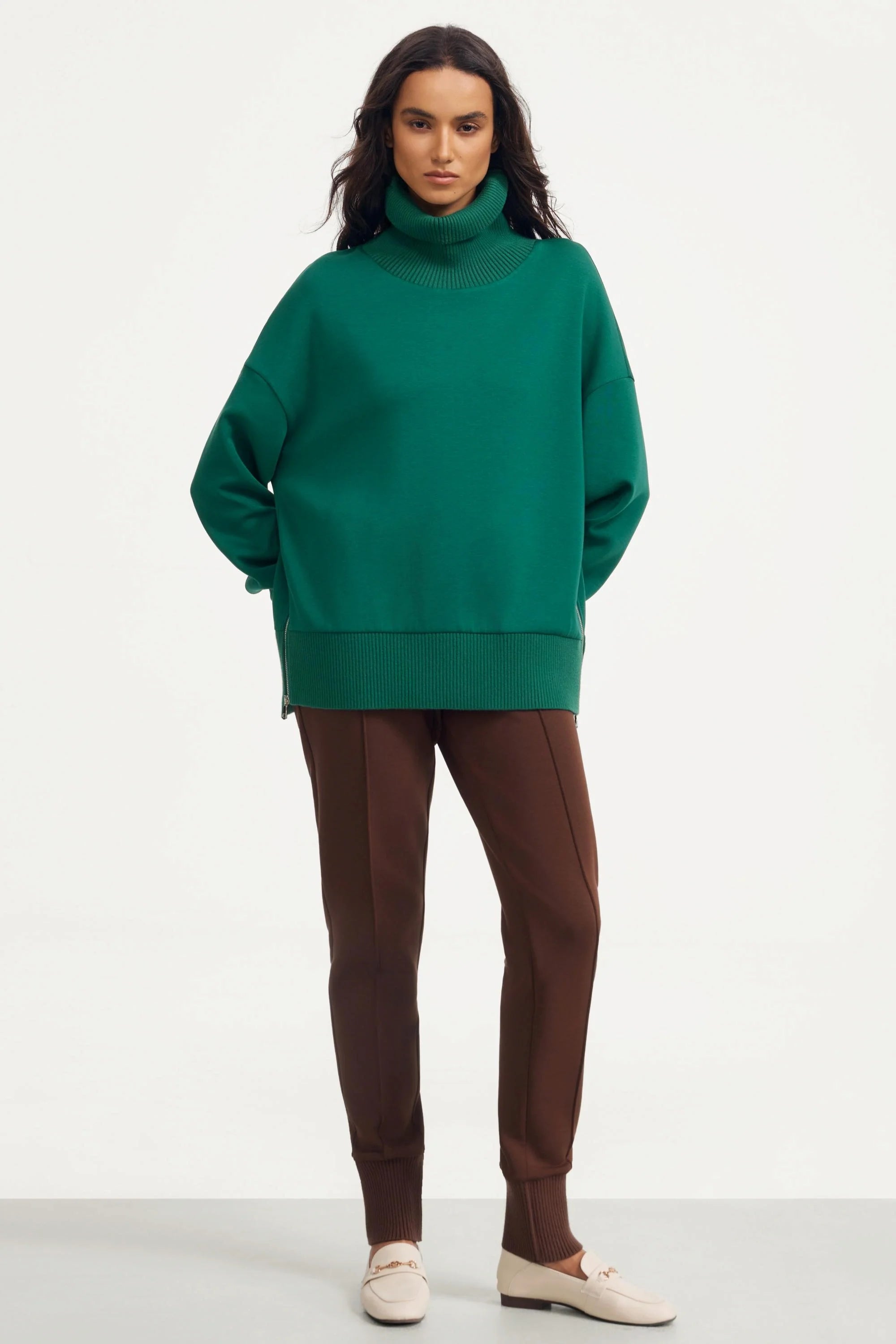Women’s green funnel-neck pullover styled with matching slim-fit pants