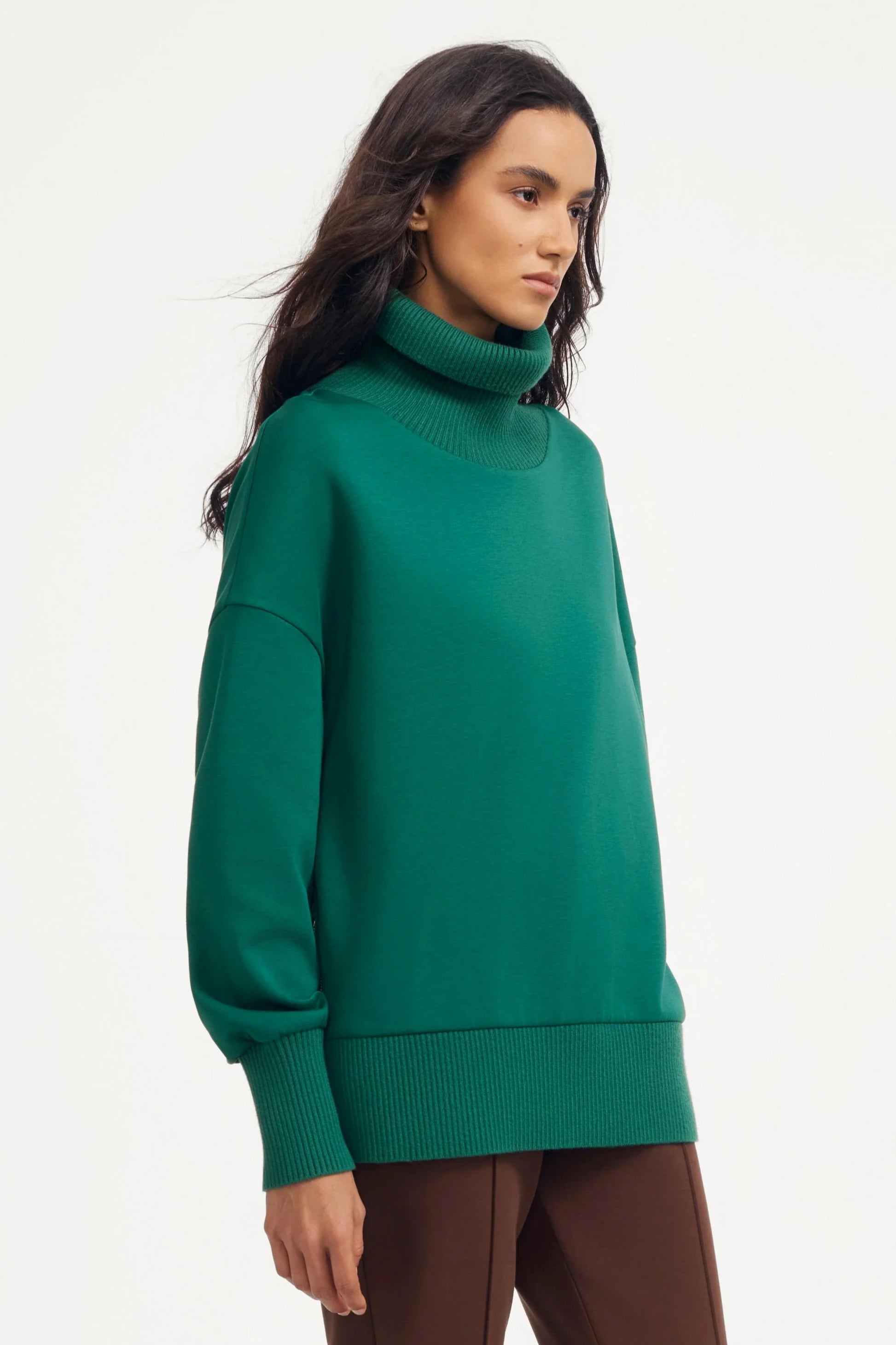 Women’s green funnel-neck pullover with ribbed funnel neck and oversized silhouette