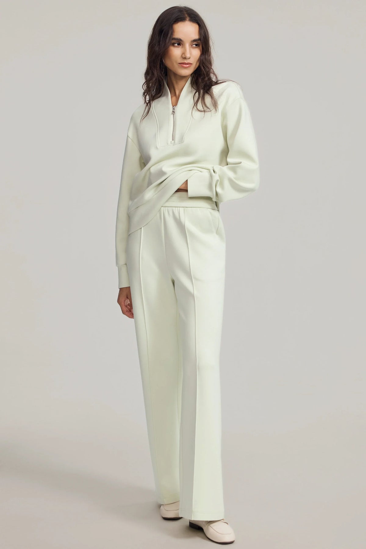 Back view of women's Pistachio Cream half-zip golf pullover with a relaxed silhouette, dropped shoulders and clean hem