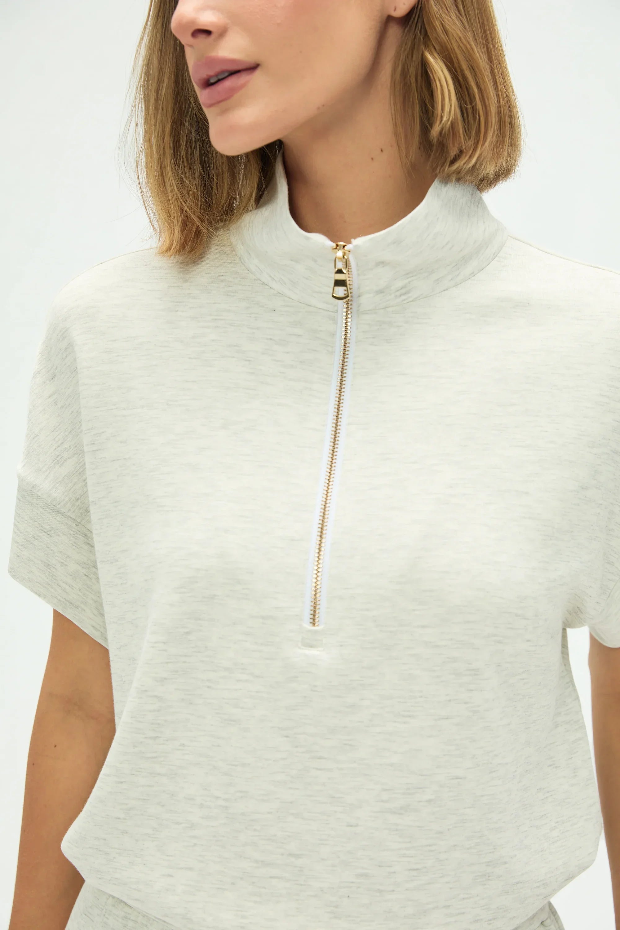 Close-up of the quarter-zip collar on women’s Heather Mist top