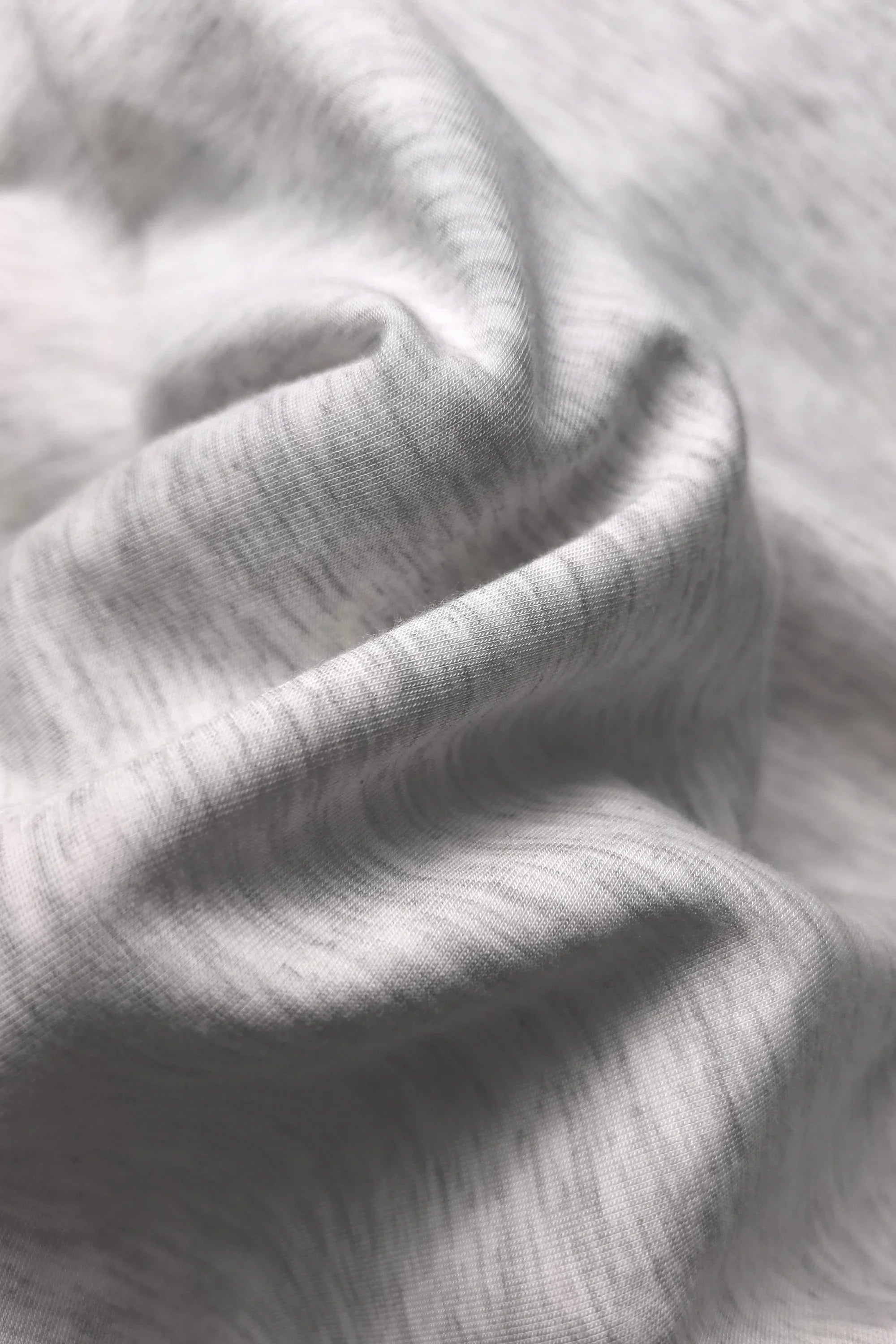 Close-up of soft Heather Mist Tencel-blend fabric used in women’s quarter-zip top