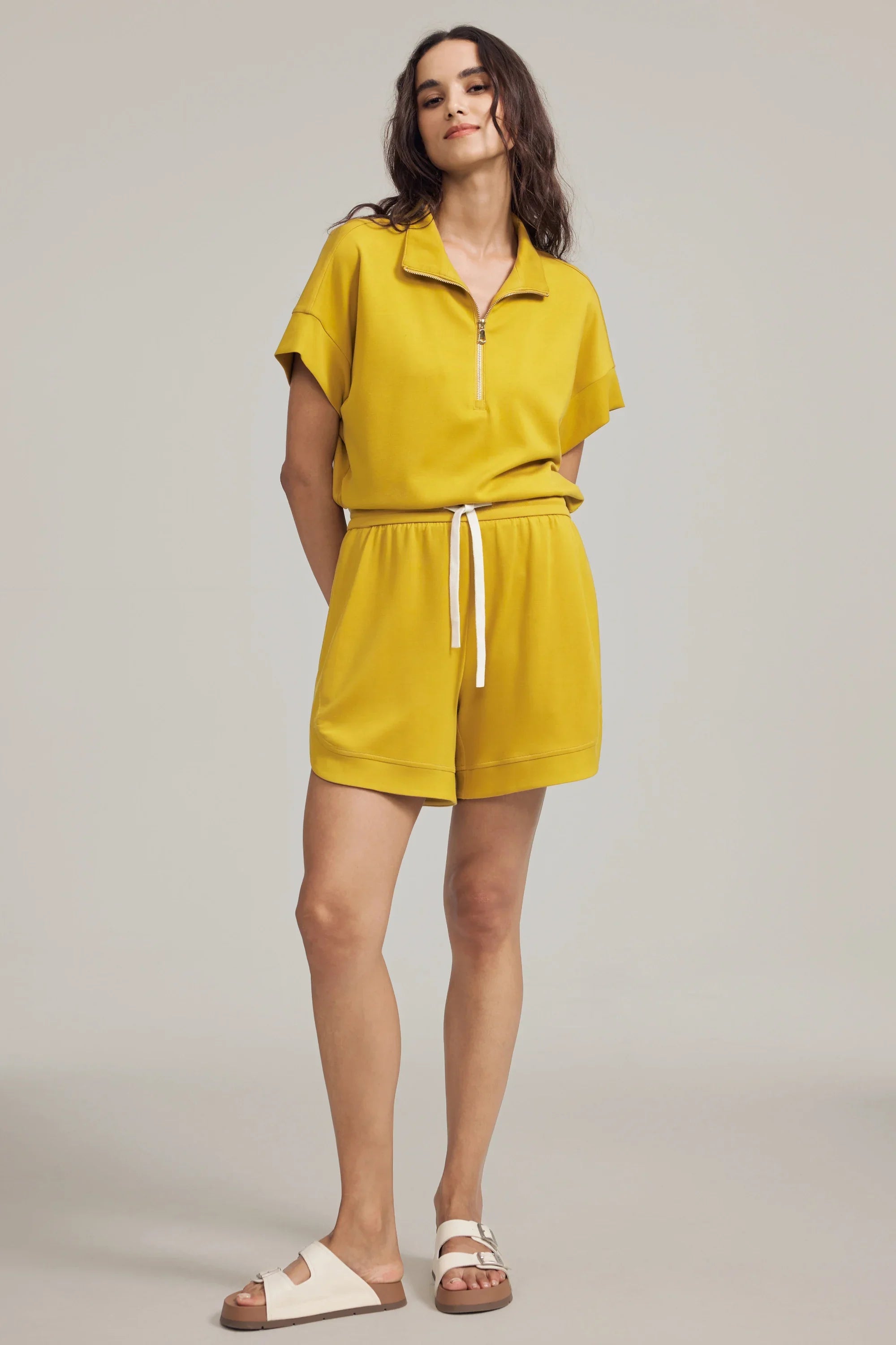 Women’s marigold performance quarter-zip top styled with matching drawstring shorts