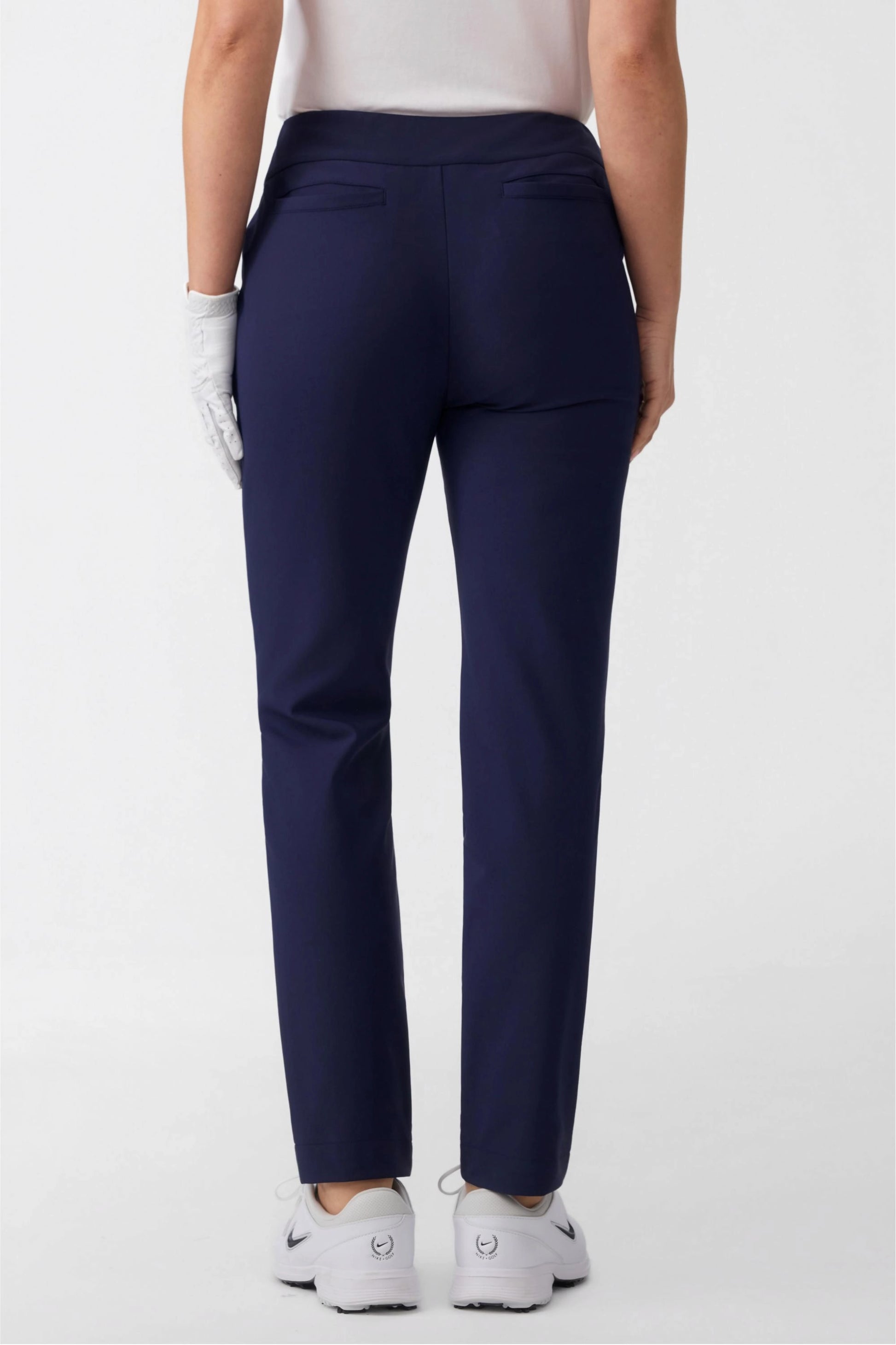 Back view of women’s midnight navy stretch golf pants with clean back pocket detailing