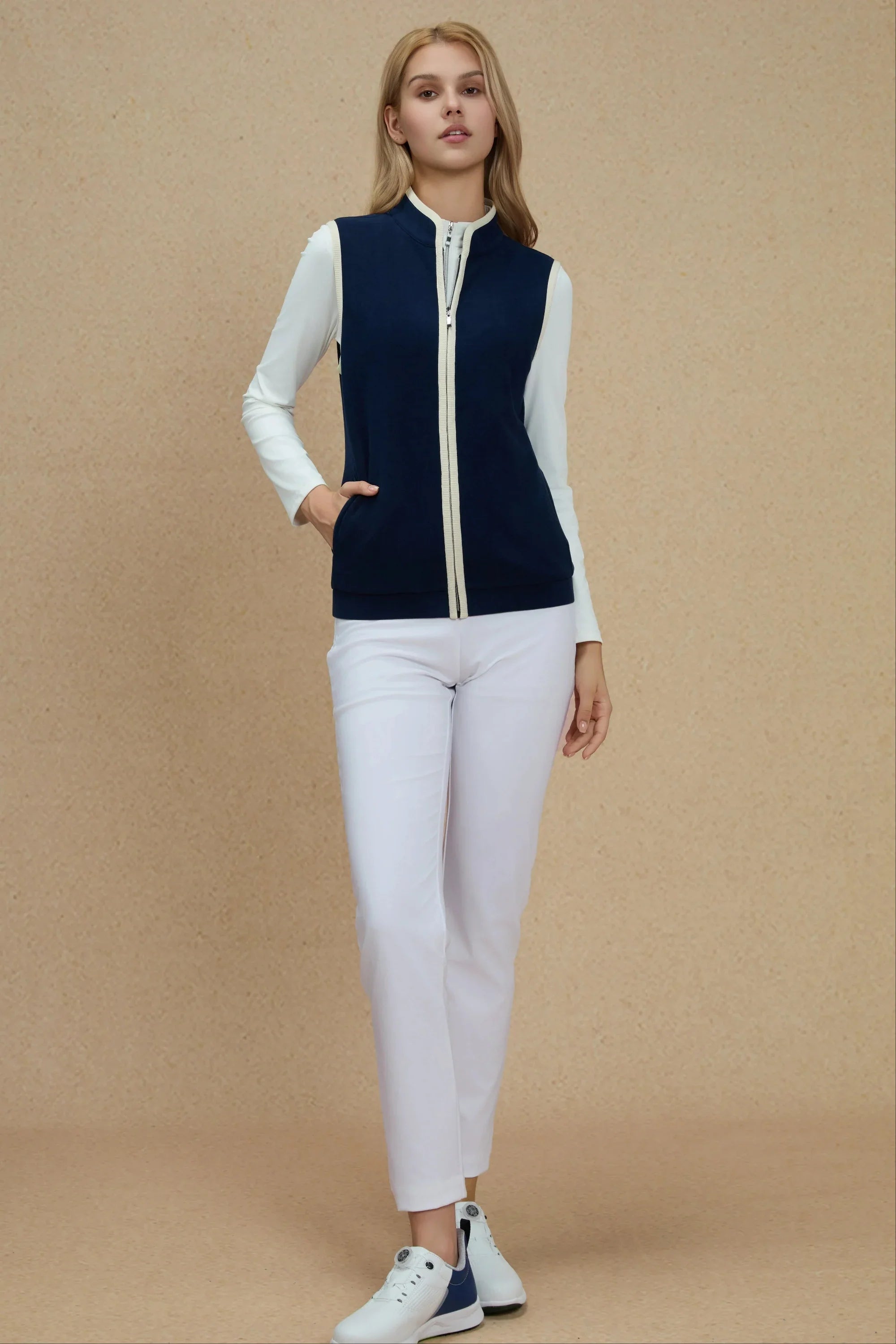 Full outfit view of Women’s Midnight Navy zip-front golf vest styled with white pants