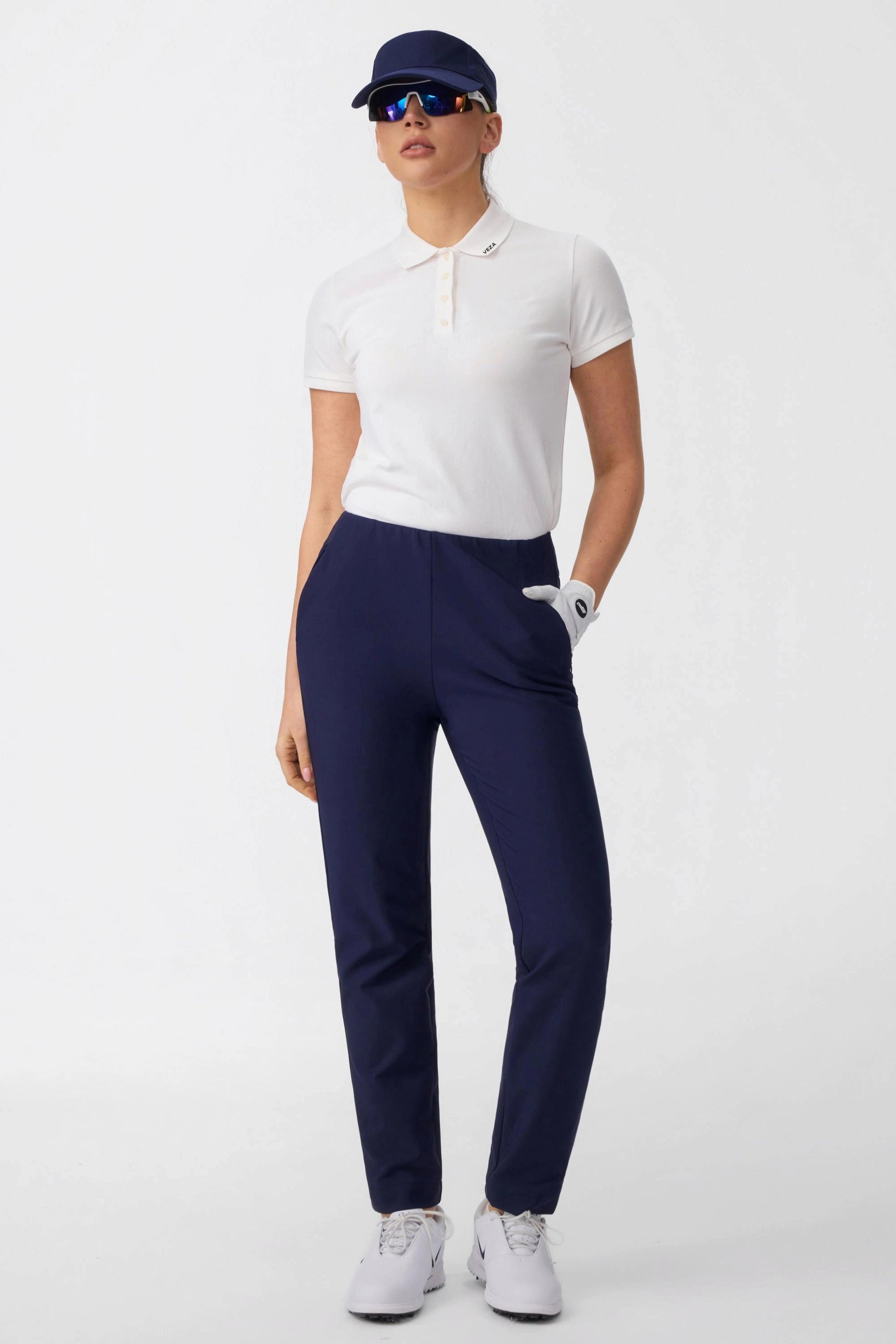 Front view of women’s midnight navy stretch golf pants with high-rise waist and straight-leg fit