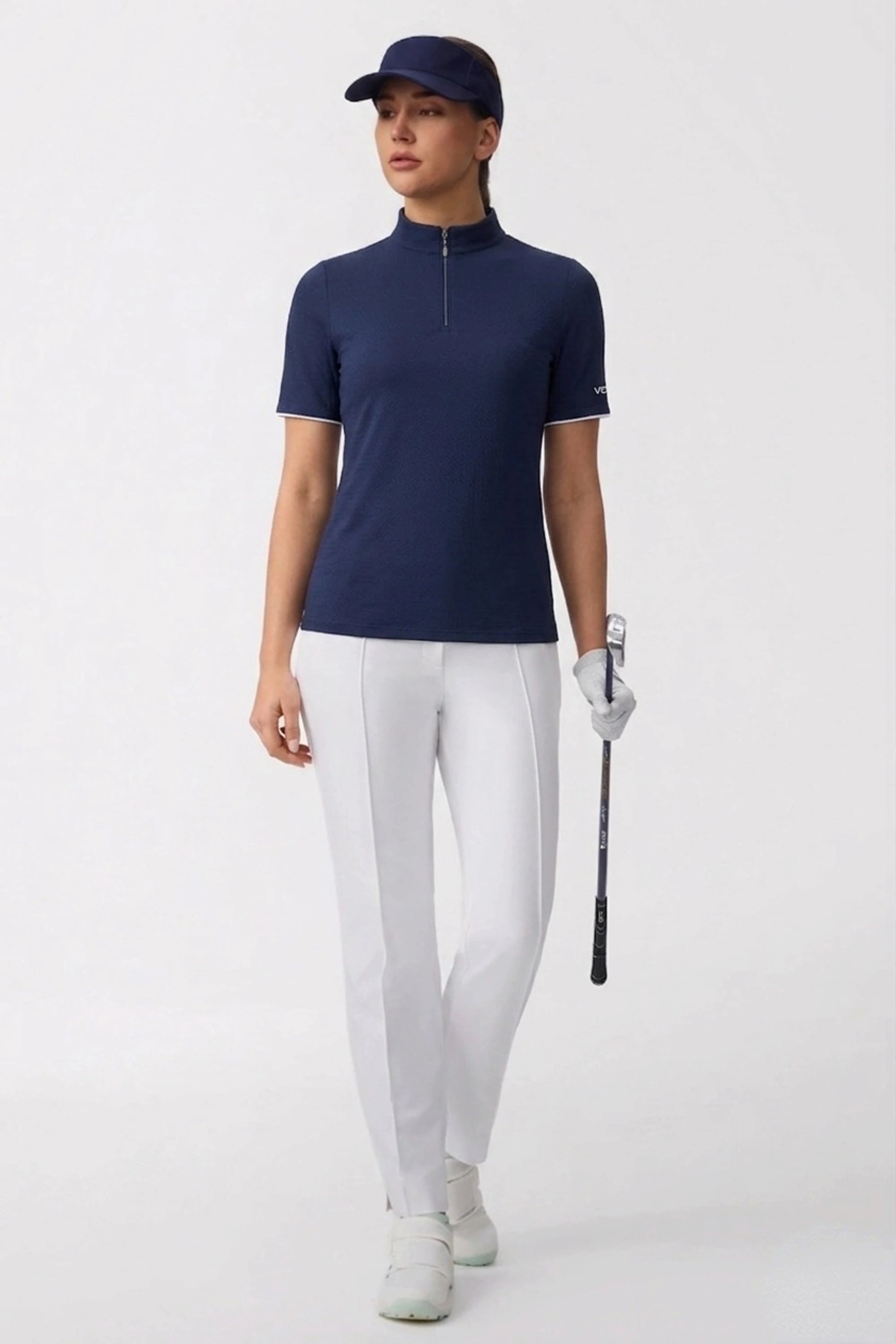 Women’s performance golf top in navy with zip neck collar and tailored athletic silhouette