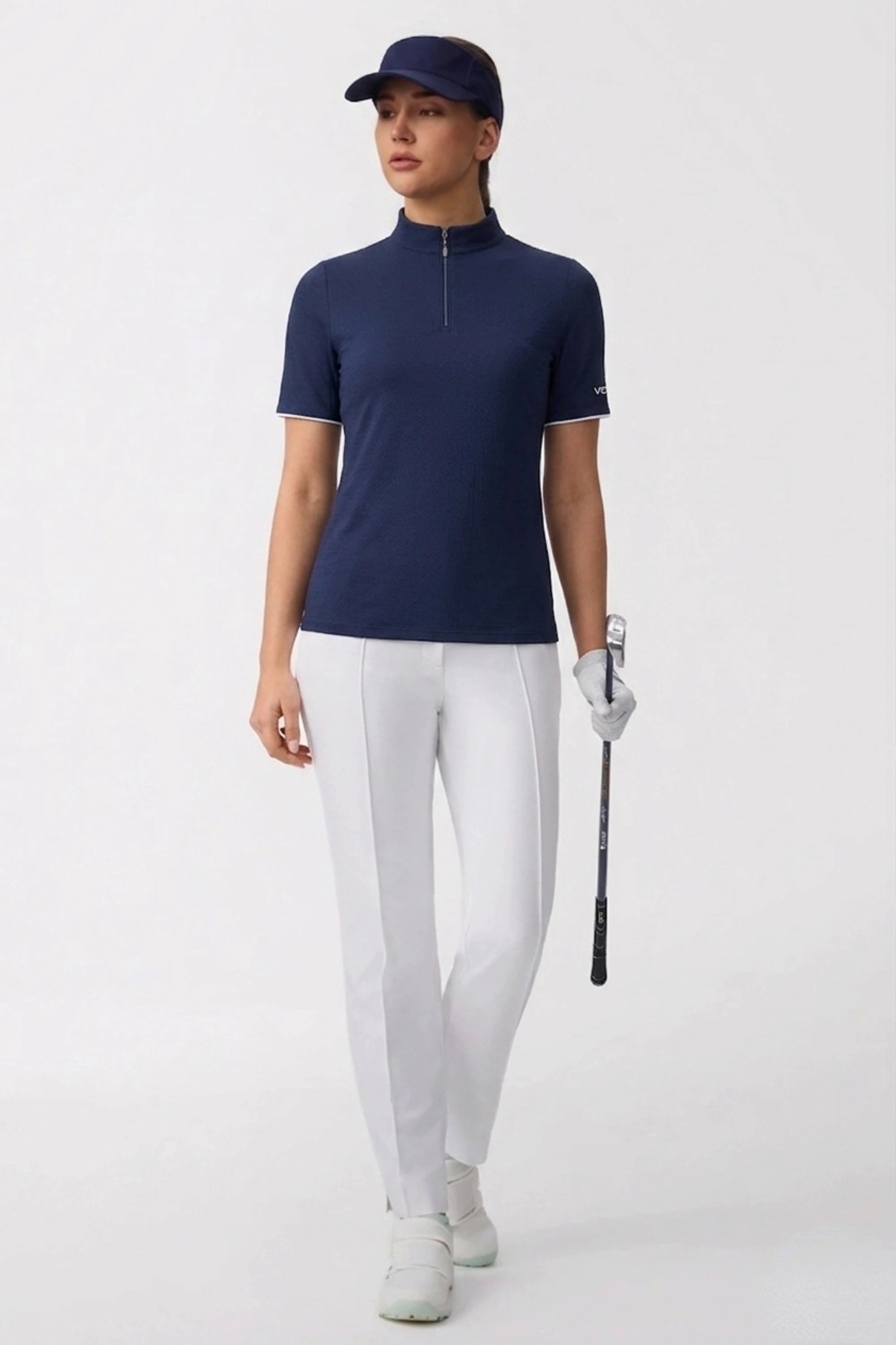 Women’s performance golf top in navy with zip neck collar and tailored athletic silhouette
