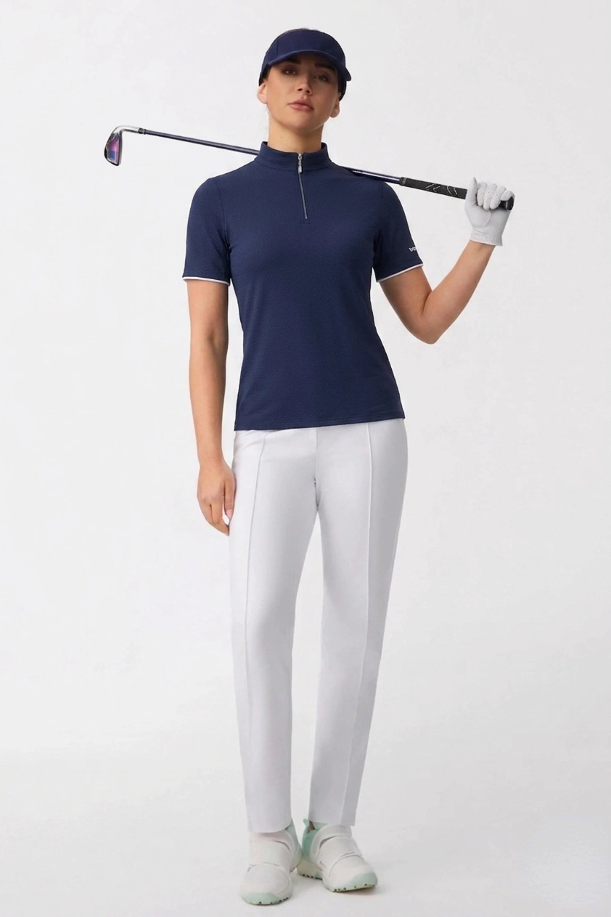 Women’s navy quarter zip golf top styled for golf with a sleek fit and comfortable performance fabric