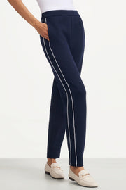 Side view of women's Midnight Navy slim fit golf pants with contrast piping and side pocket